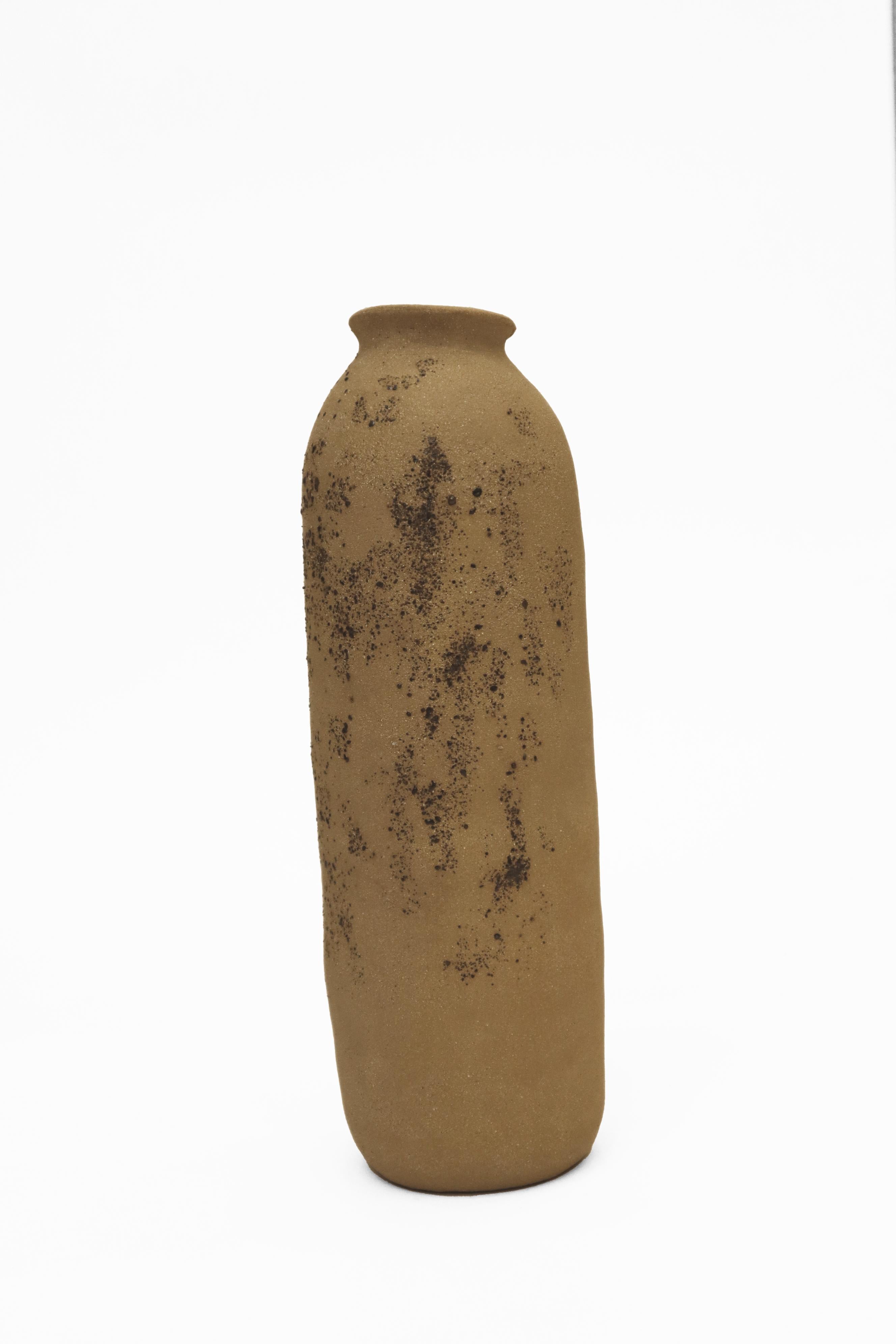 Stomata 6 vase by Anna Karountzou
Dimensions: D 9 x H 31 cm
Materials: Beige stoneware clay, clear glaze inside, decorated outside with volcano rocks collected from Santorini, fired at 1240

Born and based in Athens, Greece, with a background in