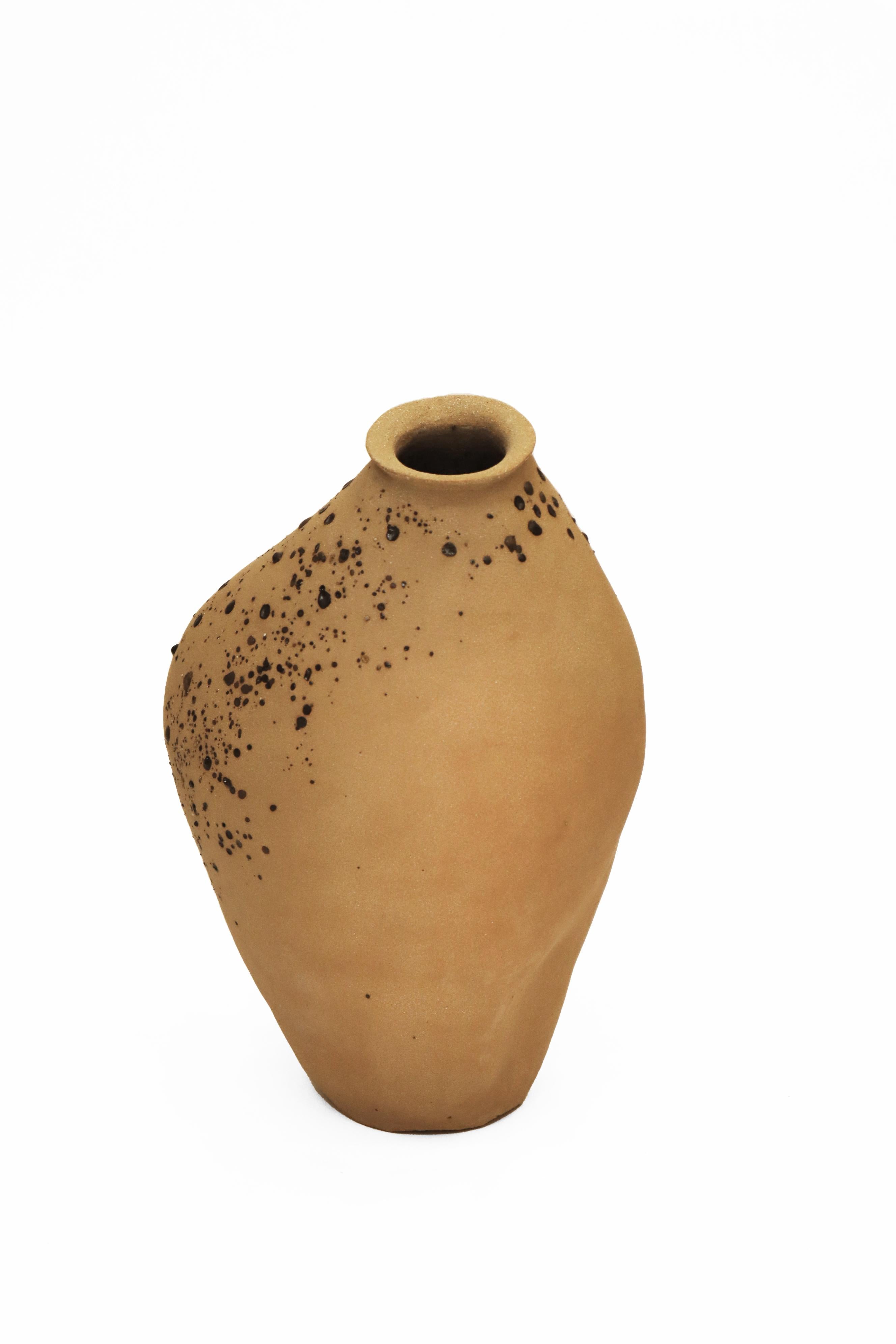 Stomata 8 Vase by Anna Karountzou
Dimensions: W 18 x D 15 x H 31.5 cm
Materials: Beige stoneware clay, clear glaze inside, decorated outside with volcano rocks collected from Santorini, fired at 1240

Born and based in Athens, Greece, with a