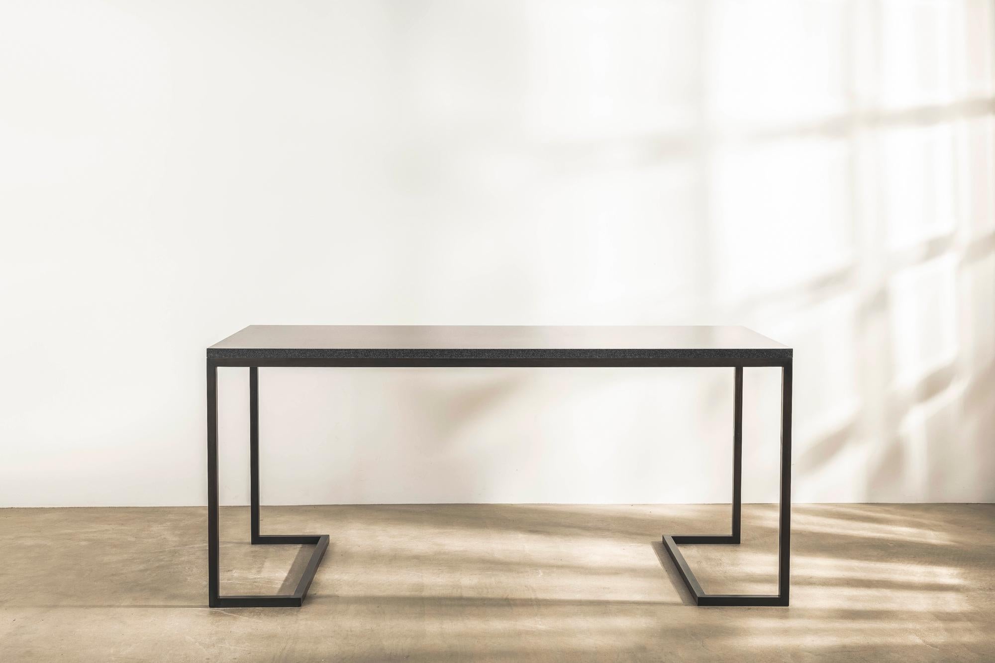With a focus on clarity of line, form and function, this special edition desk with Indian honed granite top and angular patinated brass frame, is almost 2 metres long and stands an imposing 85cm high.

Designed by revered British architectural