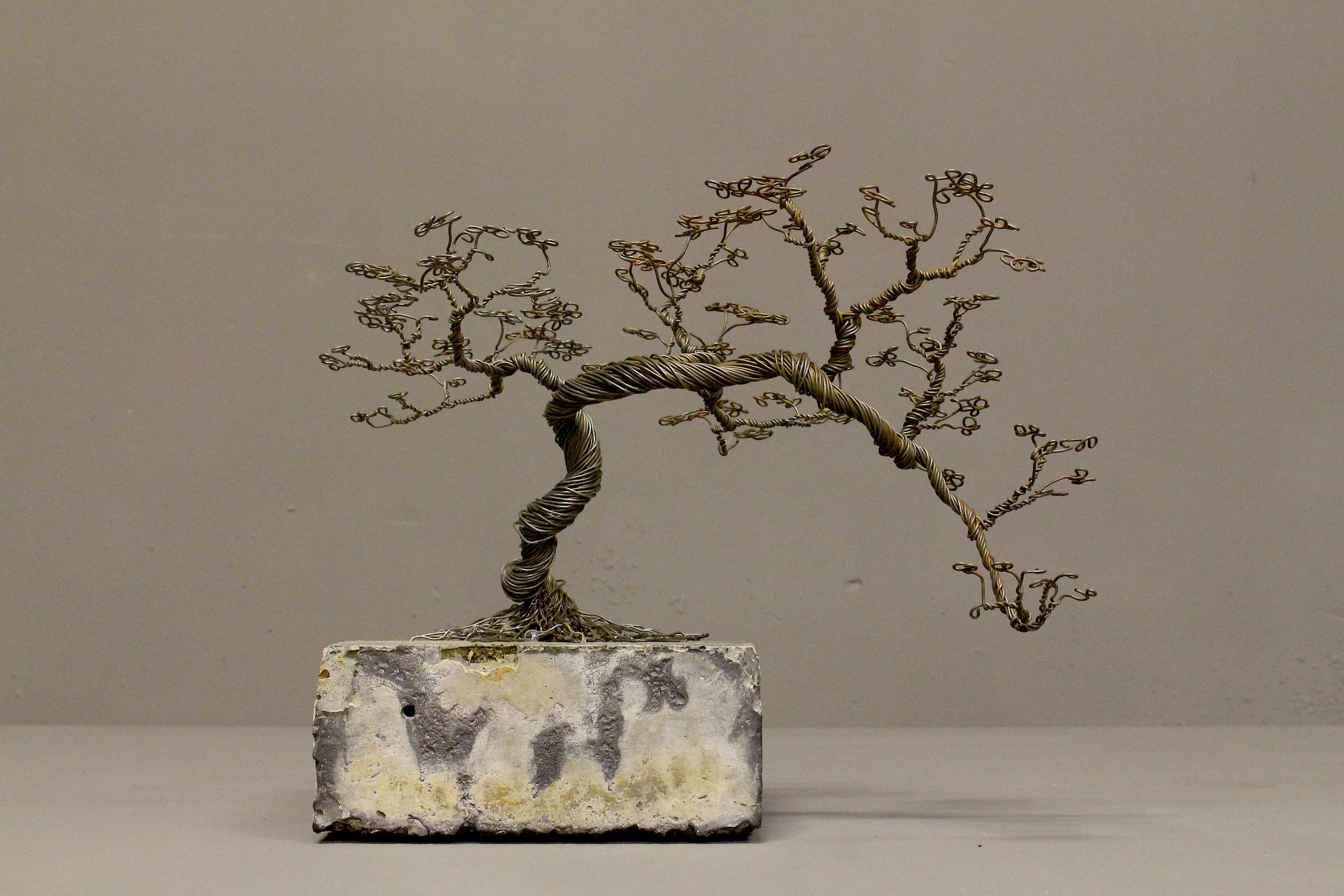 A stone and iron 'Bonsai' tree sculpture by Dutch artist Bastiaan Beun.
The slowly rusting iron is mounted on a beautiful patinated pedestal stone base.
The handcrafted iron tree is very detailed and it invites you to deform yourself.
This