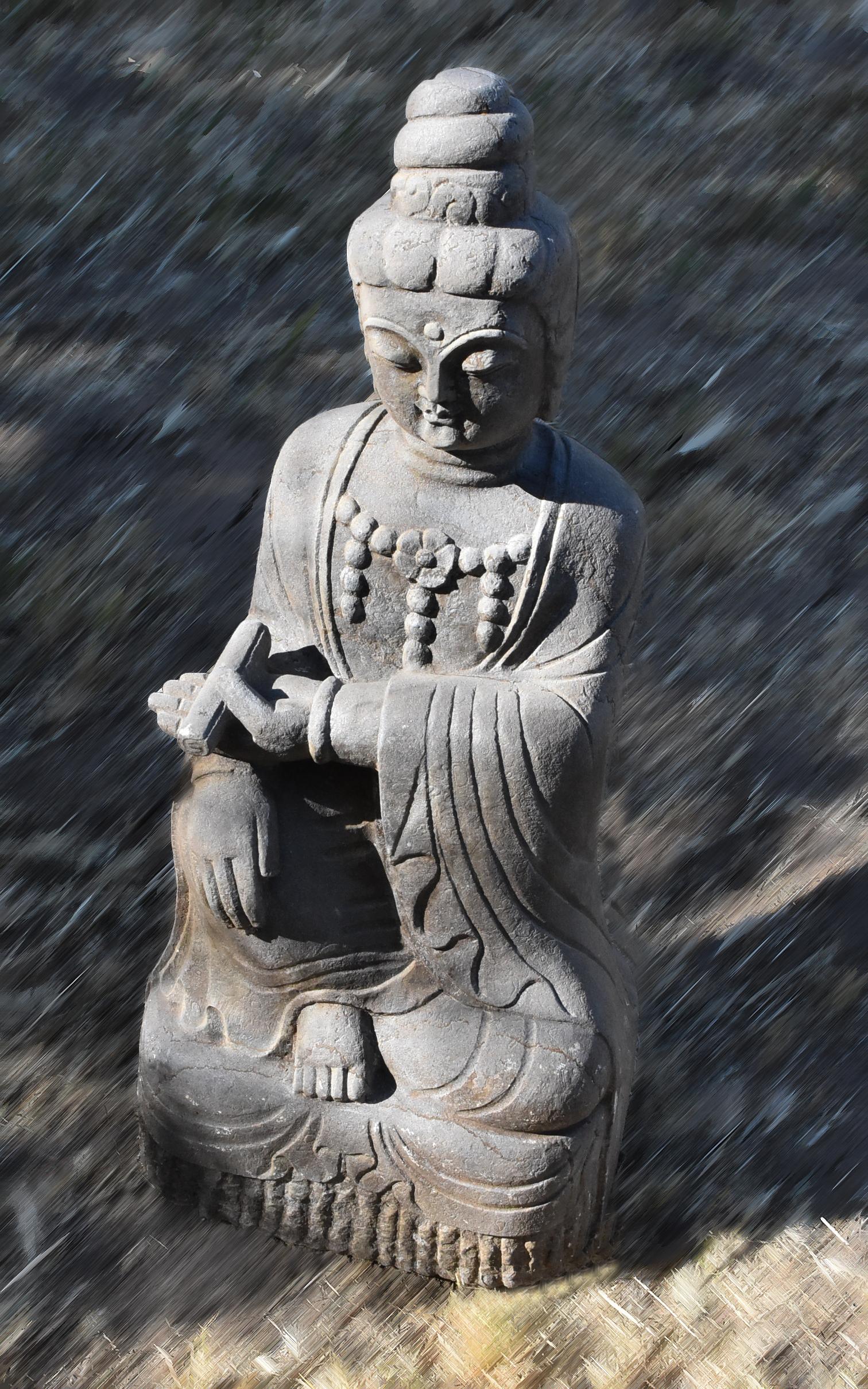 A beautiful hand carved statue of Goddess of Compassion, Kwan Yin, as a teacher. Kwan Yin is seated with her right hand on the right leg up on a solid base, left hand holding a scroll of book. Dressed in a robe draping over her torso, covering both