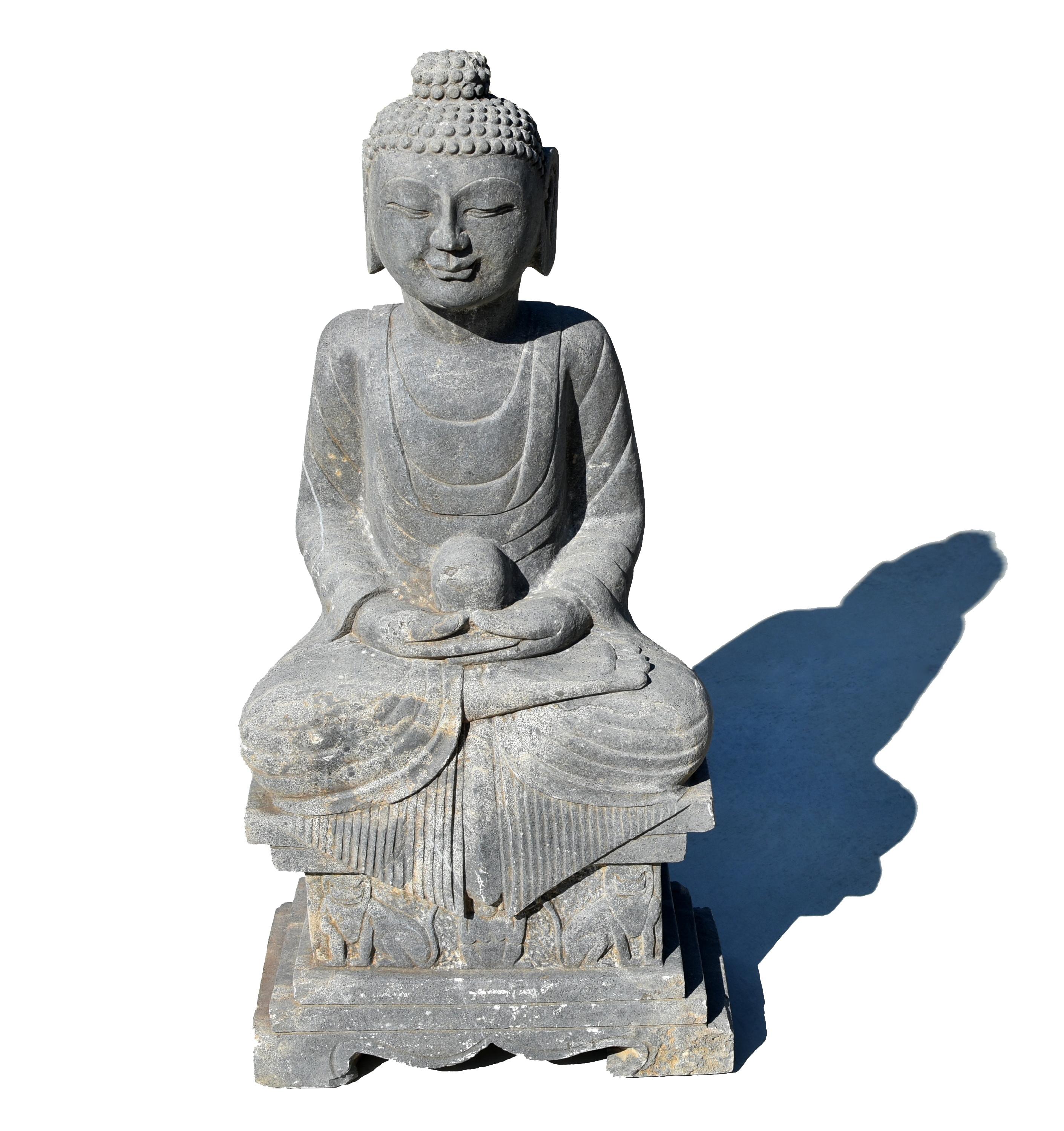 A large, finely carved Tang style stone statue of Buddha Amitabha. Depicted with a full-cheeked face below neatly gathered hair and ushnisha, with large eyes, downcast smile and full pursed lips, all flanked by long pendulous earlobes. Dressed in a