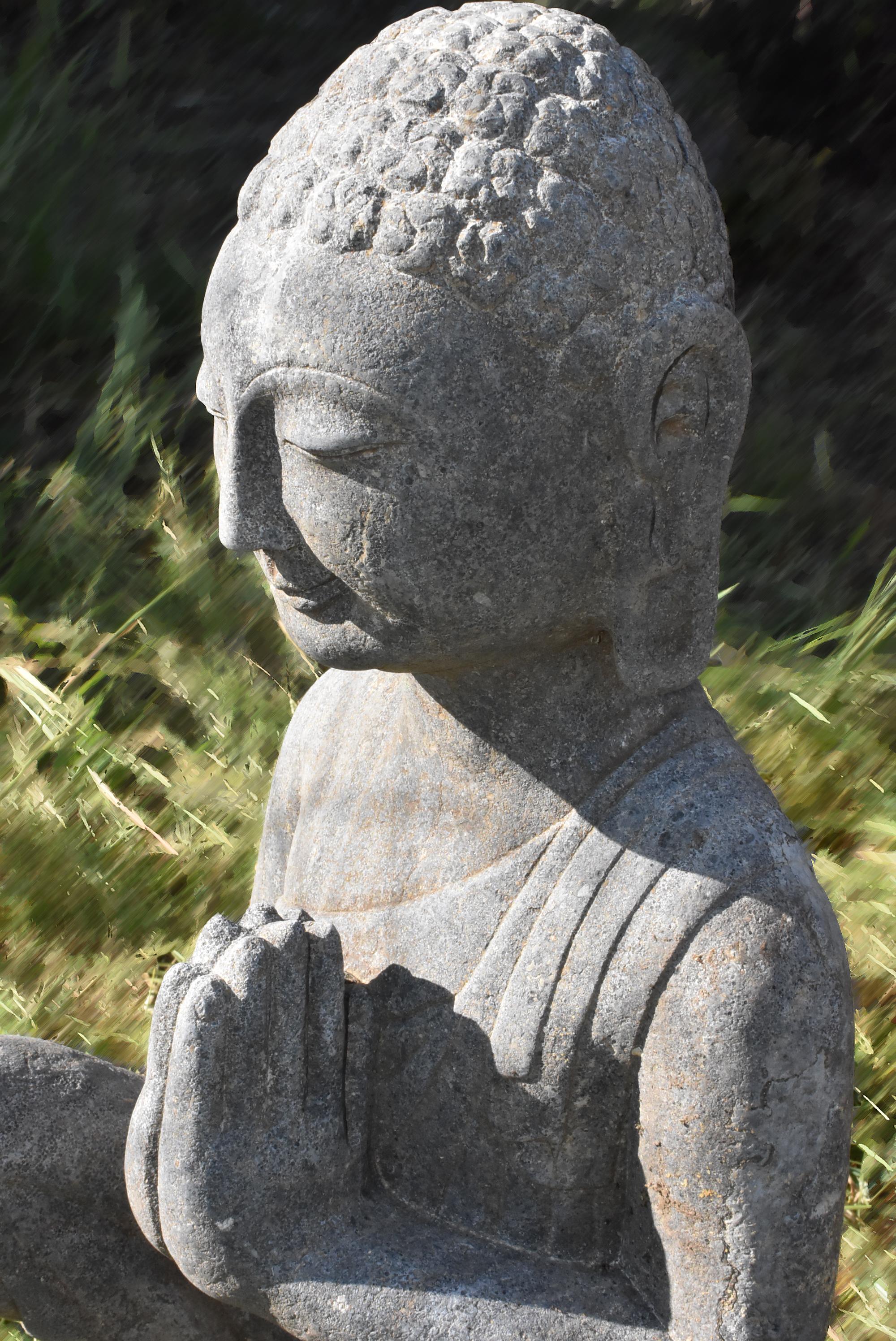 A beautiful hand carved statue of Buddha in the Northern Wei style. Buddha is seated with the right leg up on a lotus base, both his hands forming Namaskara Mudra symbolizing devotion, prayer, and admiration, dressed in a robe draping over his torso