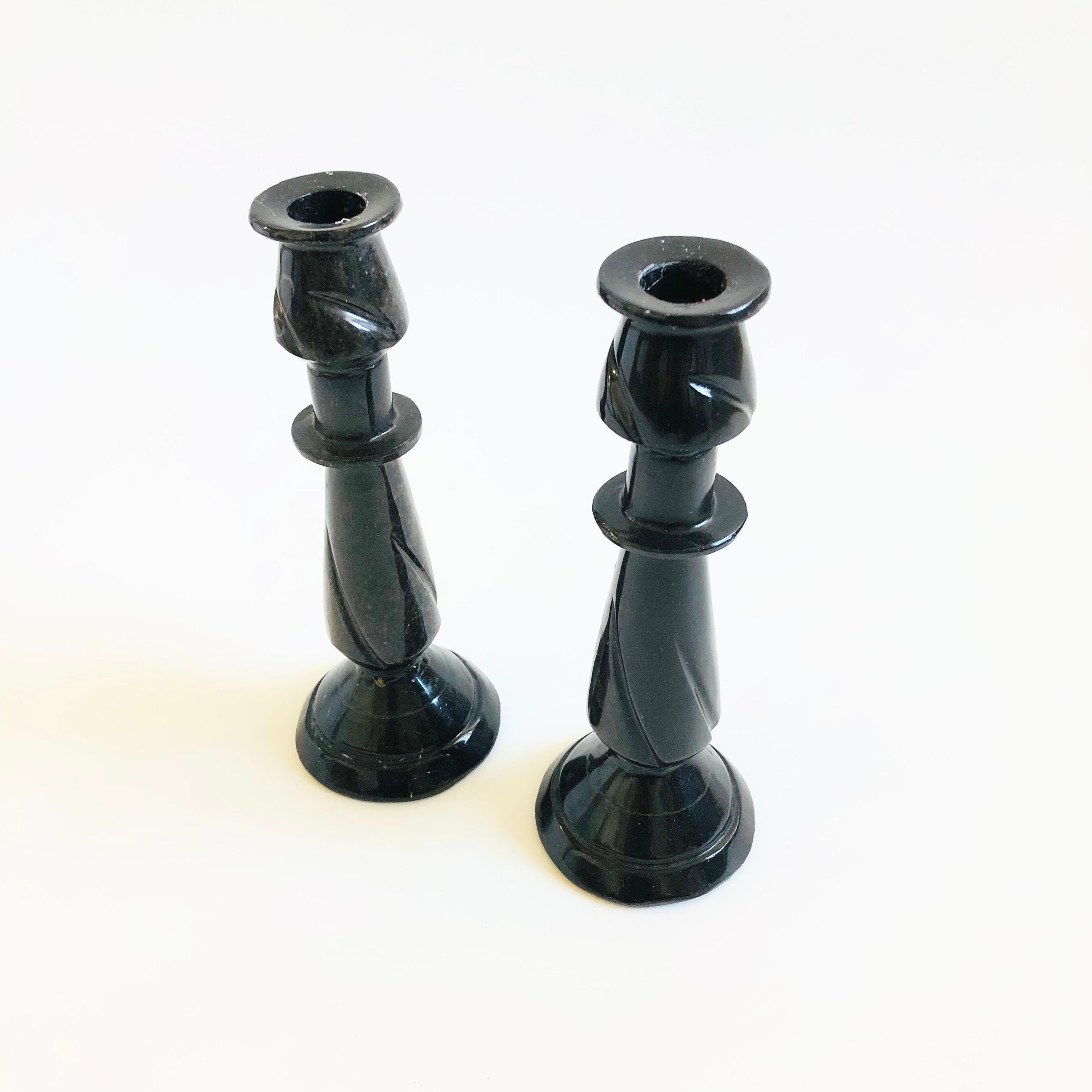 A pair of vintage carved stone candle holders. Moody black color to the stone.

