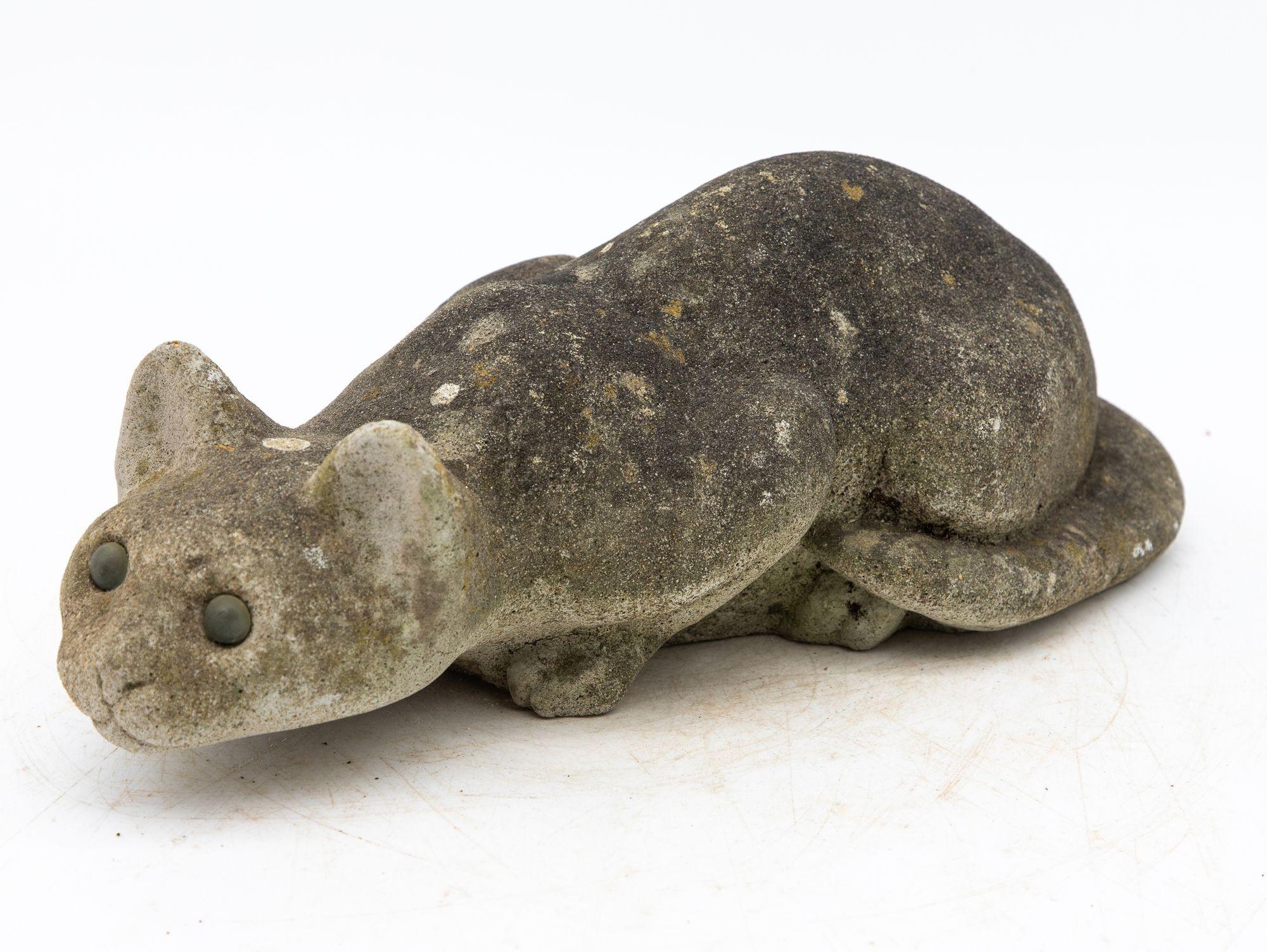 This 1960s-era French composite stone cat epitomizes feline grace and agility, frozen in a captivating hunting pose. With a sleek, low profile and back legs coiled in anticipation of a pounce, its slightly elevated head exudes an air of vigilant