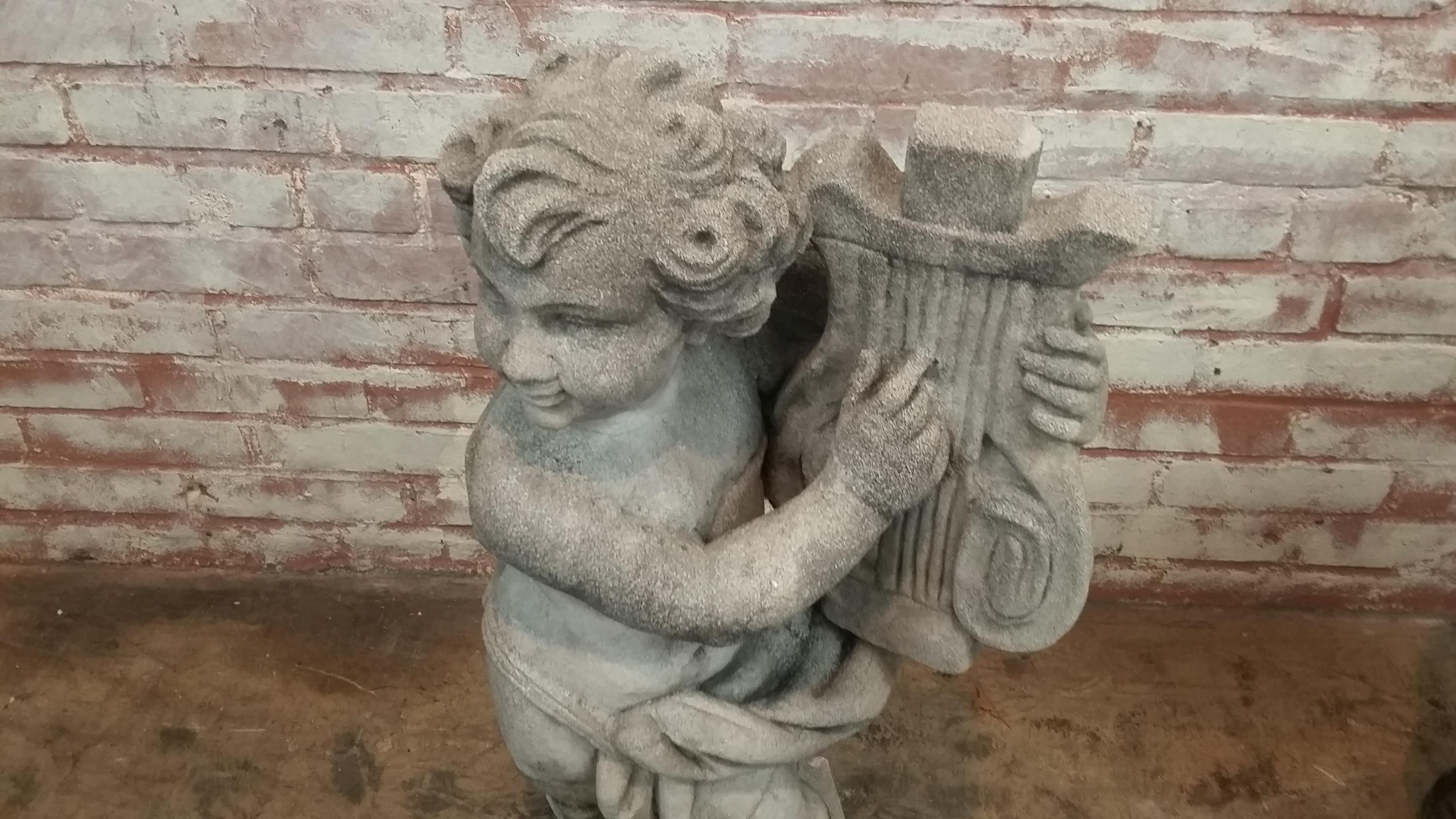 Stone Cherub holding Lyre statue (late 20th century) originally made in England from reconstituted stone. Signed on back David Sharp & Co. Inc. Great vintage 