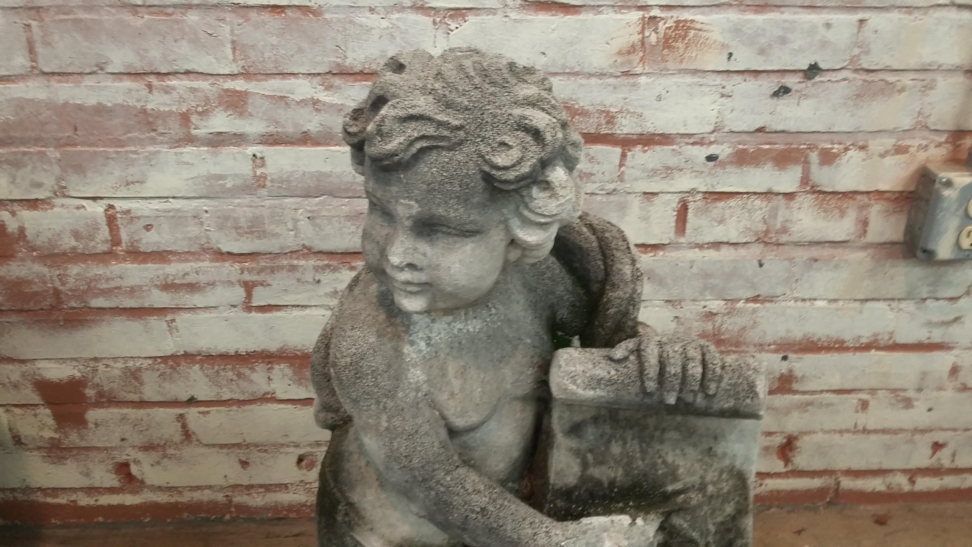 Stone Cherub holding scrolled tablet statue (late 20th century) originally made in England from reconstituted stone. Signed on back David Sharp & Co. Inc. Great vintage 