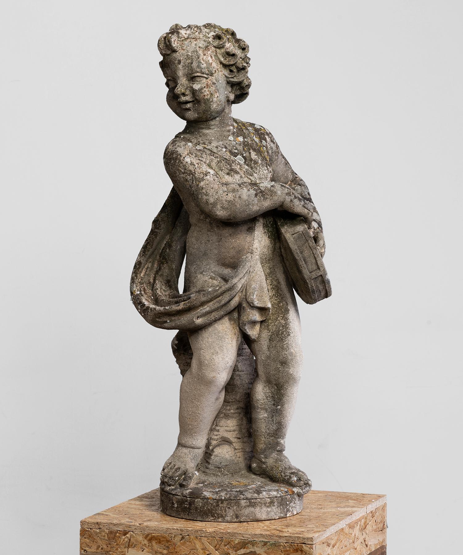 Cast stone garden statue of cherub with tambourine. wonderful patina.