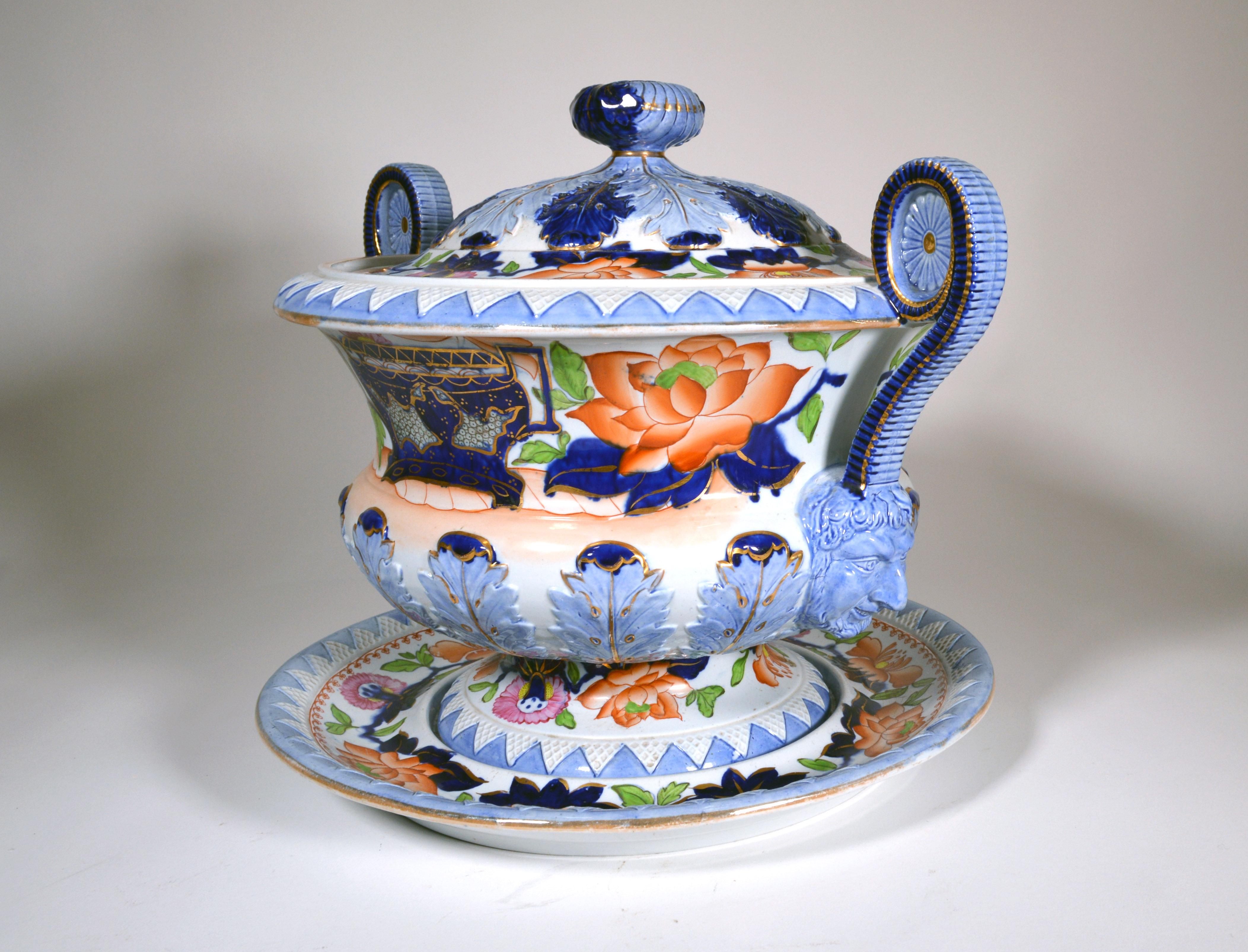Stone China Soup Tureen. Cover and stand, 
Hicks & Meigh, 
circa 1810-1820 
 

The very large molded and rather dramatic soup tureen cover and stand are painted in Imari colors, The terminals of the handles have a spectacular molded image of