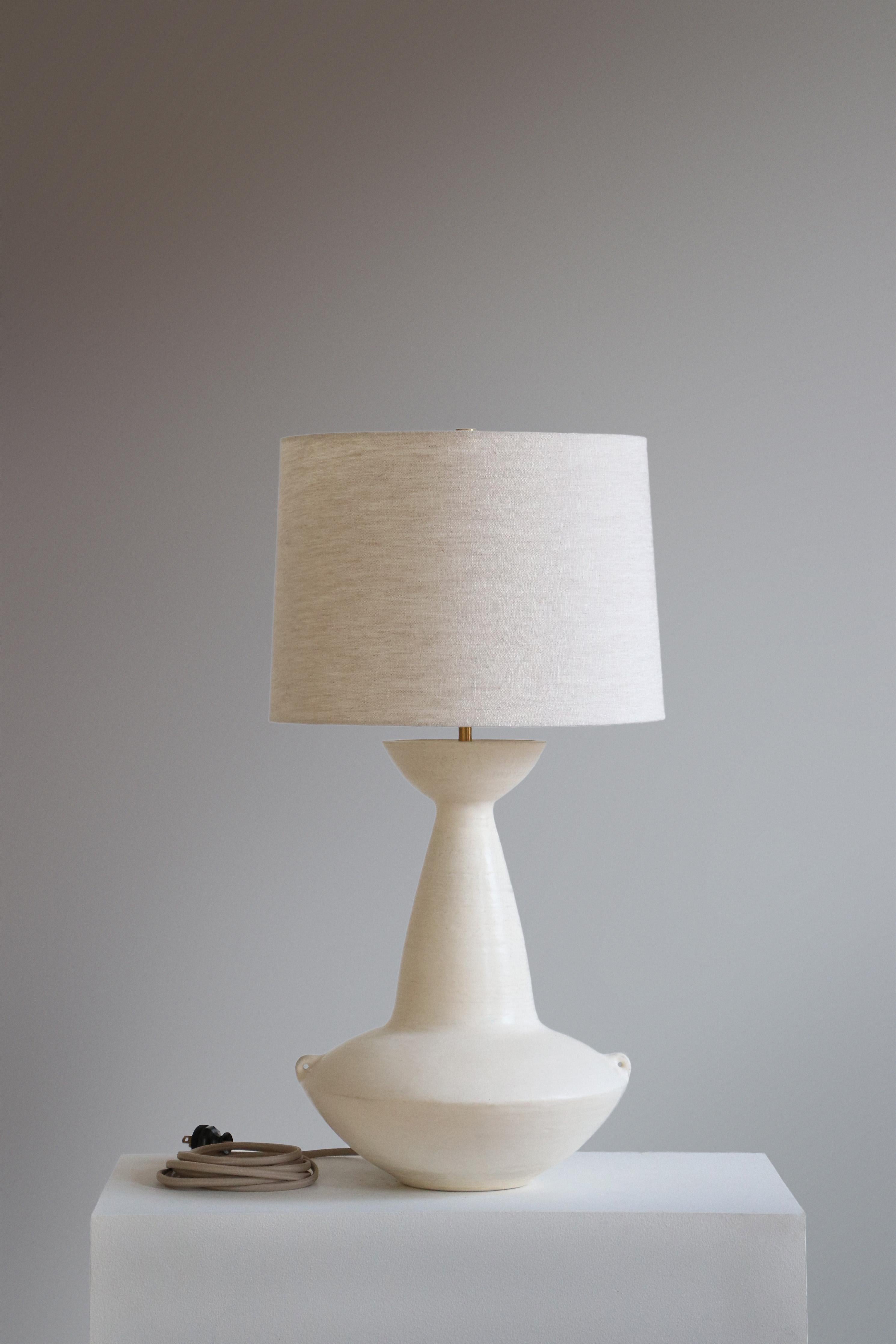 Stone Claudius Table Lamp by Danny Kaplan Studio
Dimensions: ⌀ 36 x H 69 cm
Materials: Glazed Ceramic, Unfinished Brass, Linen

This item is handmade, and may exhibit variability within the same piece. We do our best to maintain a consistent