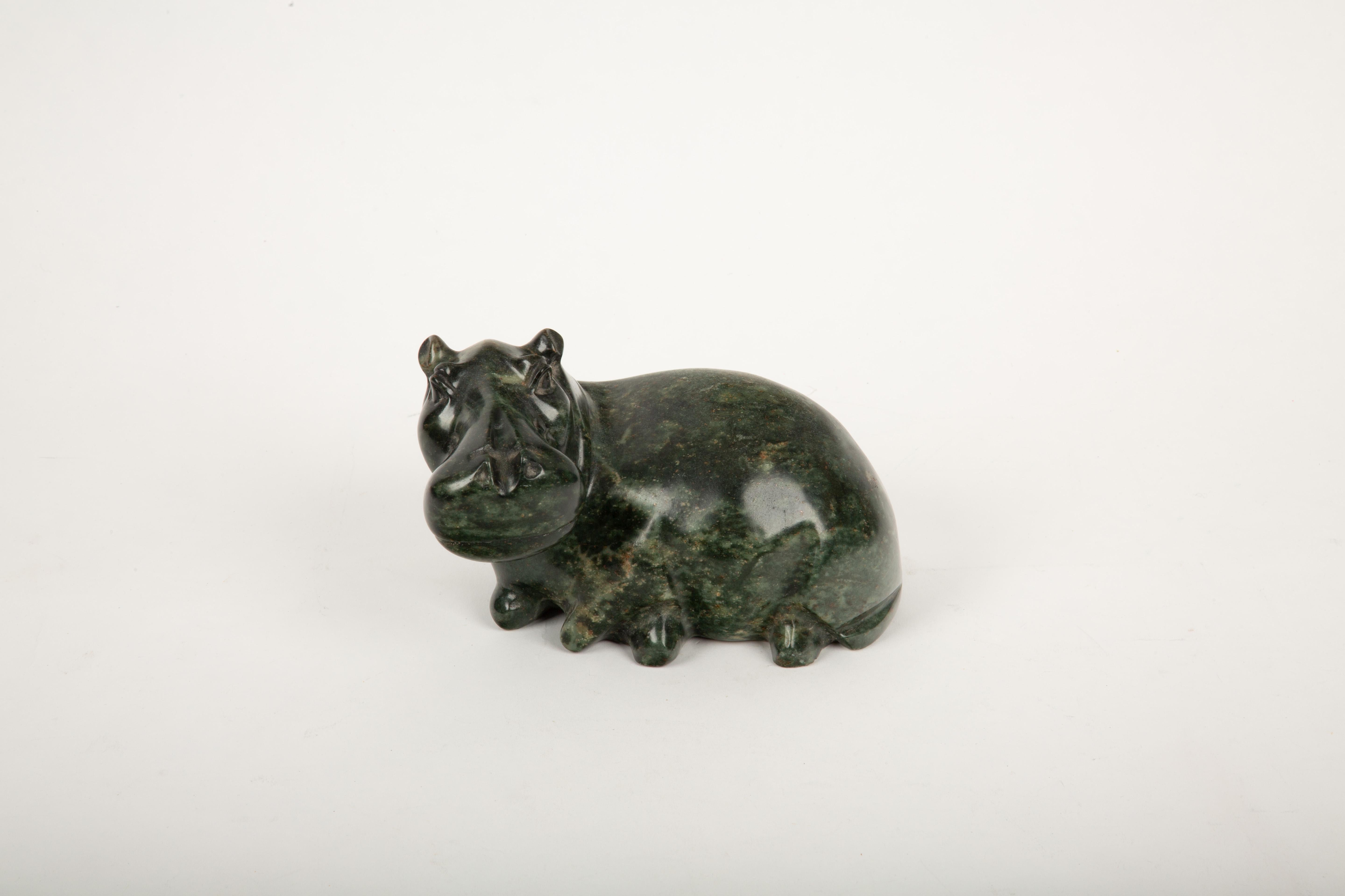 This exquisite hand-carved soapstone hippo originates from Mozambique, showcasing the region’s rich tradition of stone craftsmanship. Measuring approximately 8 inches in length, this decorative piece captures the hippo’s iconic form with smooth