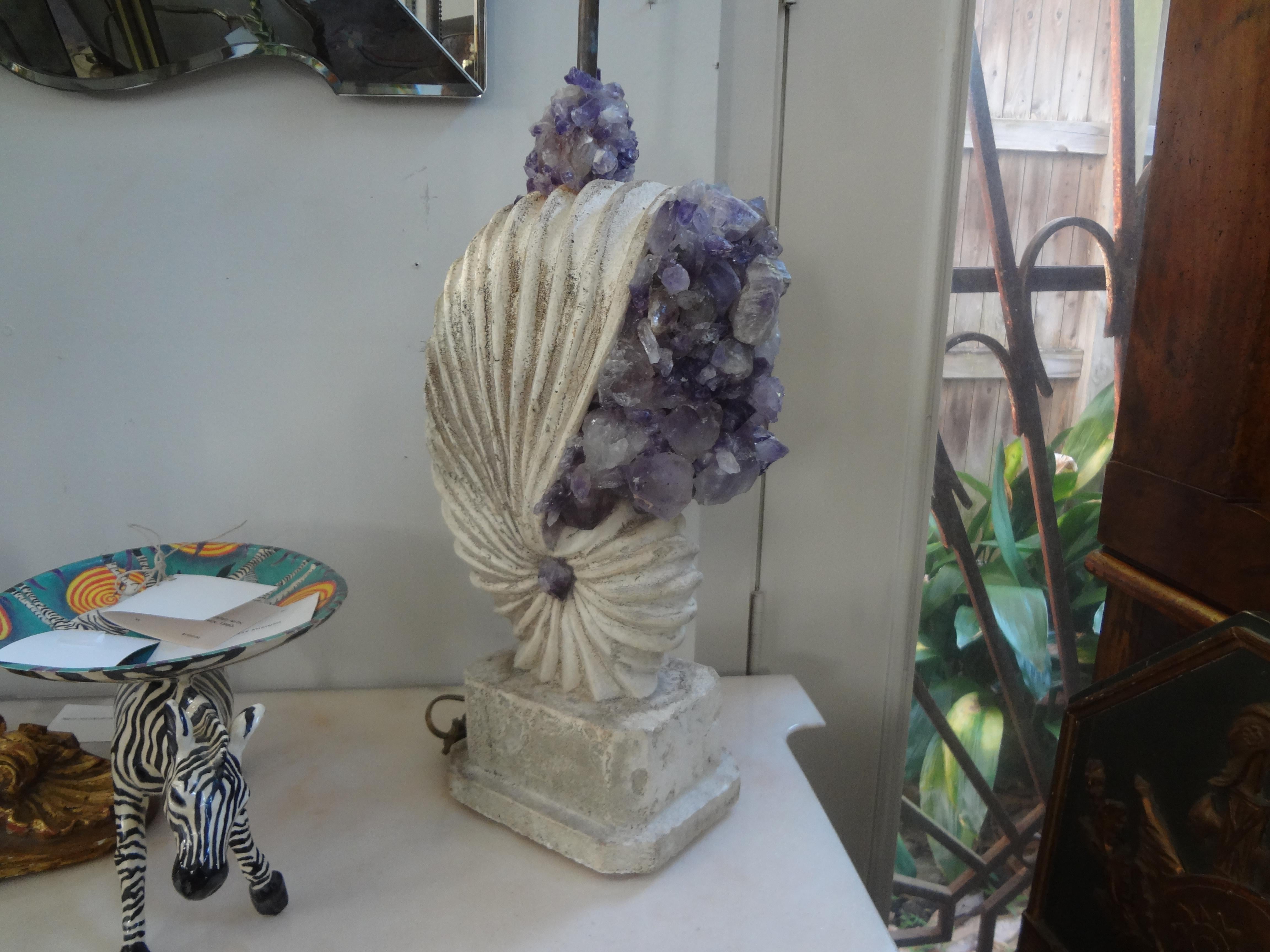Stone Nautilus shell lamp encrusted with amethyst rock crystals.
Fabulous Hollywood Regency cast stone lamp in the shape of a nautilus shell lamp encrusted with amethyst rock crystals.
This stunning rock crystal lamp has dual Edison sockets. As with