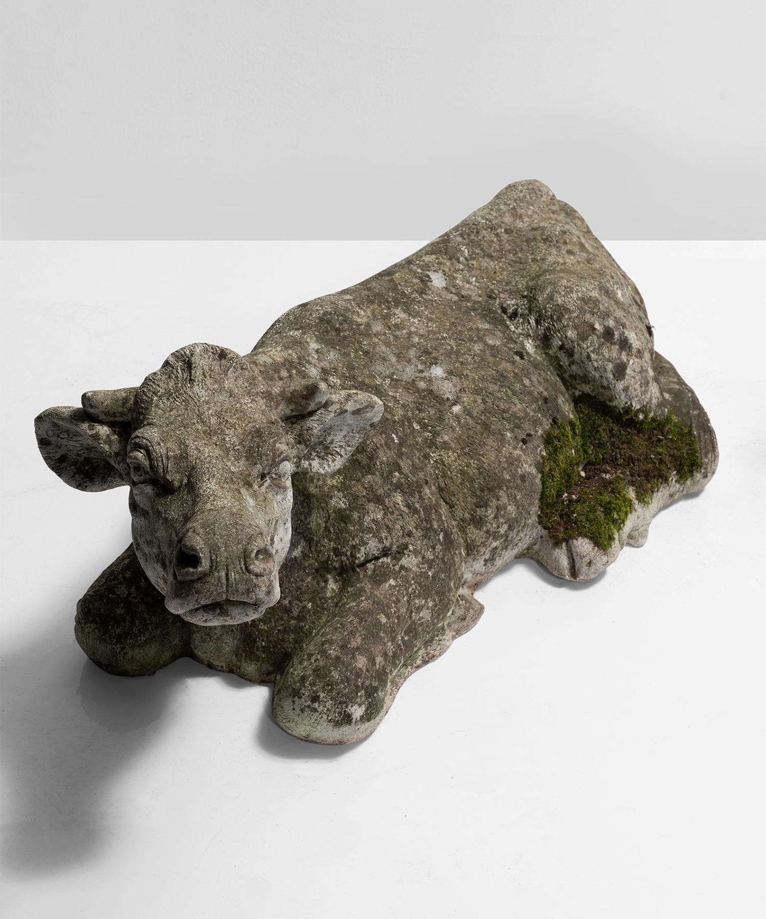 Composite sculpture of a cow lying down.