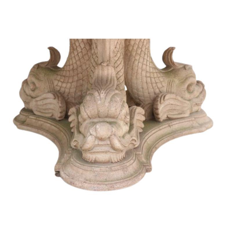 Stone top table with three dolphin base by Oscar De La Renta.