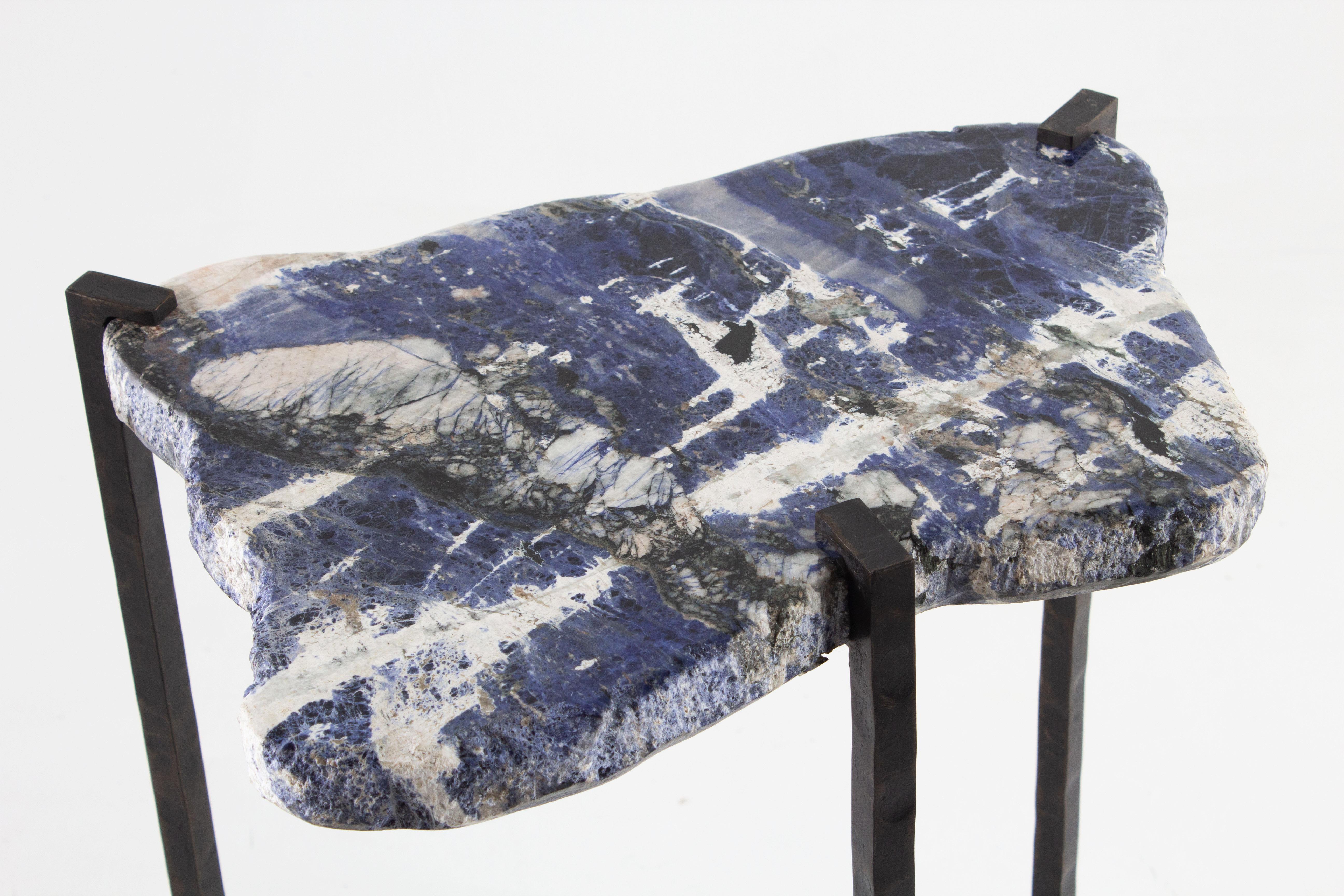 Polished Sodalite slab on hand forged oil rubbed in iron base.