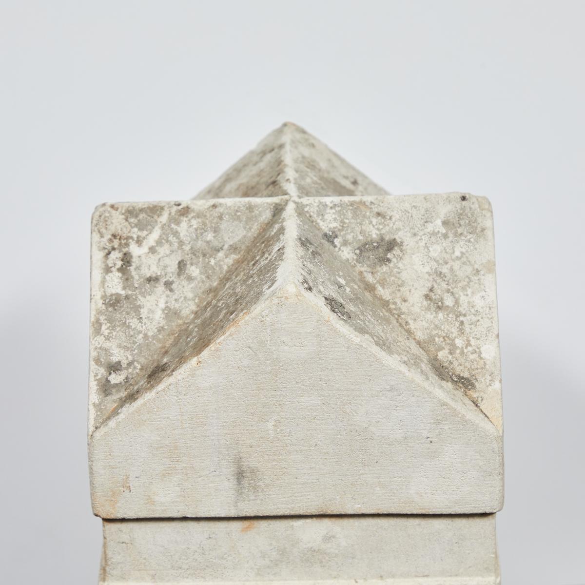 An ornamental stone from Tetbury, England. This item features a set of ornamental intersecting gables carved into the top of the stone. 
 
