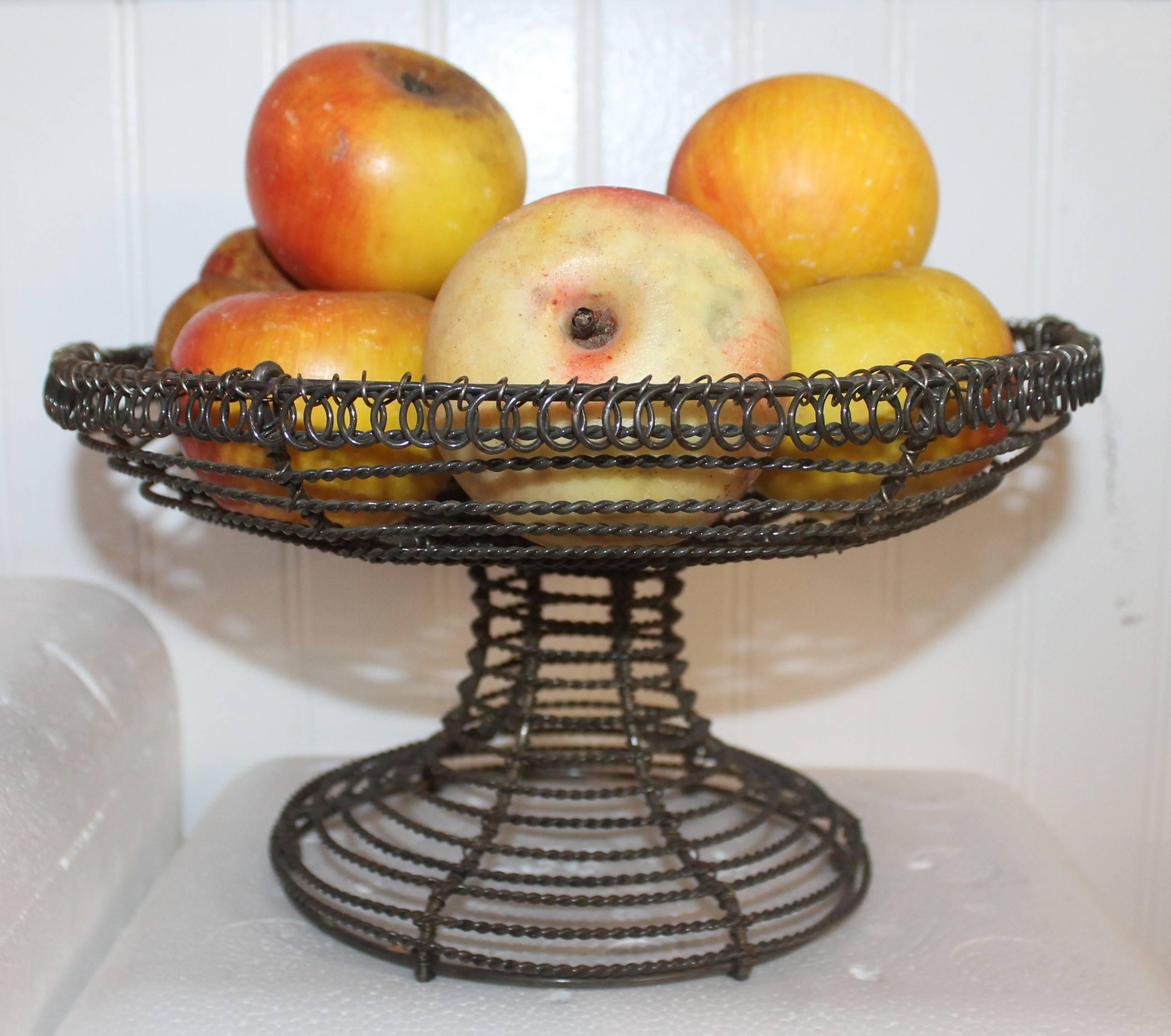 This fantastic 19th century handmade wire compote is filled with vintage stone apples. All in very good condition. Total of nine apples. Sold as a collection.