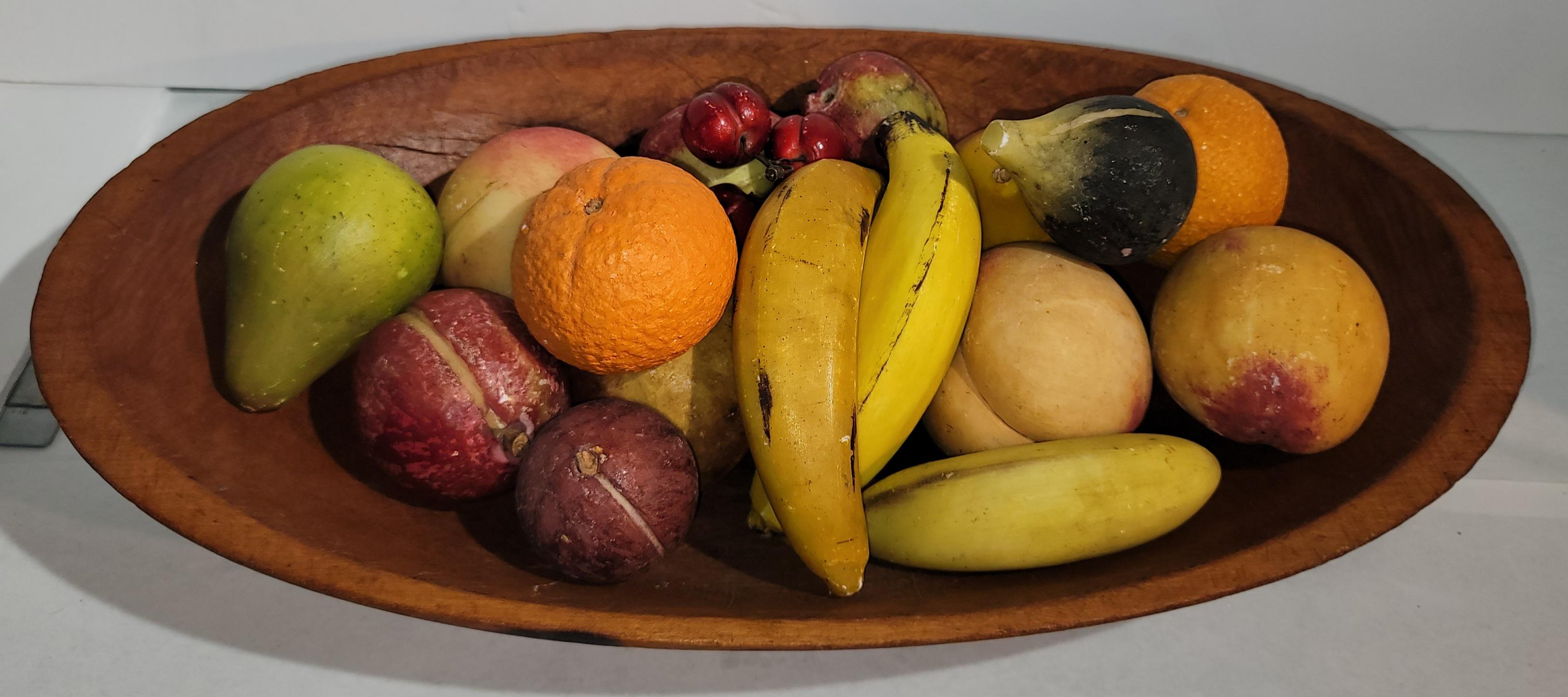 This fine collection of stone fruit of 18 pieces are in fine condition.We are including the 19thc wood dough bowl with this collection.What a great statement on a table.