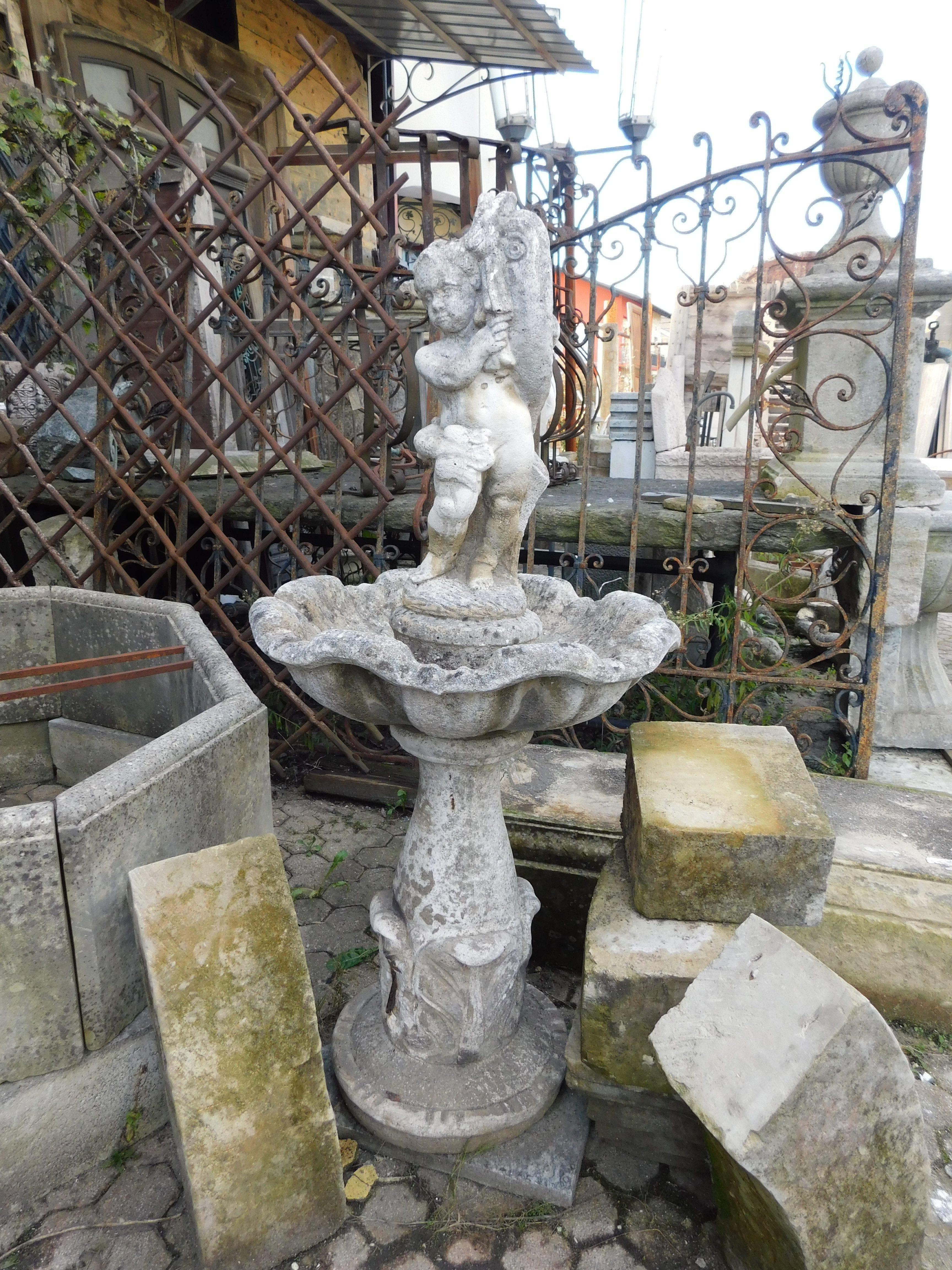 Vintage garden fountain, in artificial stone or concrete, carved with putto, basin and pedestal, built in the 1900s in Italy
tub circumference measures 60 cm x H 135, base 40 cm