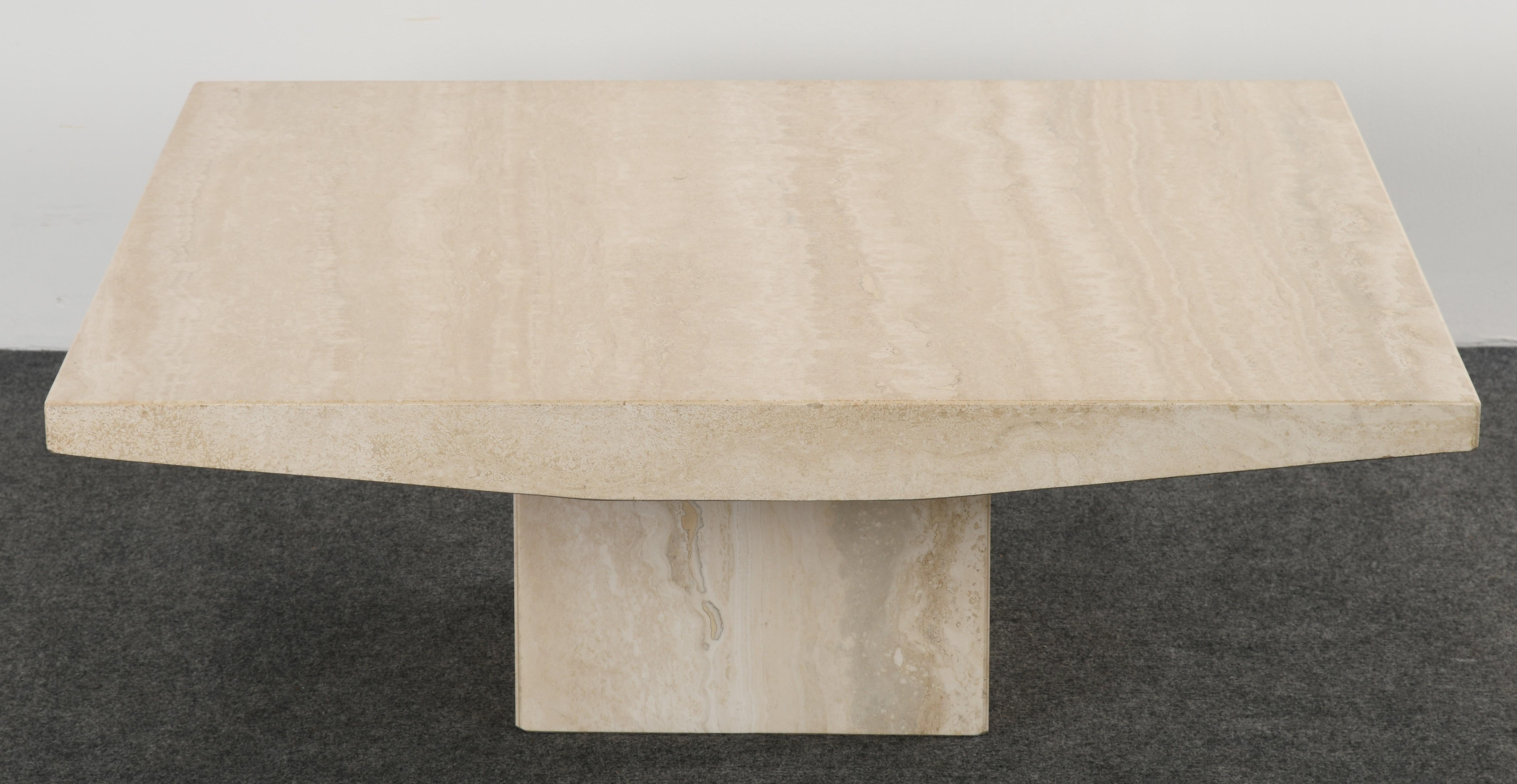 A fabulous Stone International cocktail or coffee table made of travertine marble. This Minimalist table would work in many modern interiors. Structurally sound with age-appropriate wear with some minor etching to surface, however, not distracting.