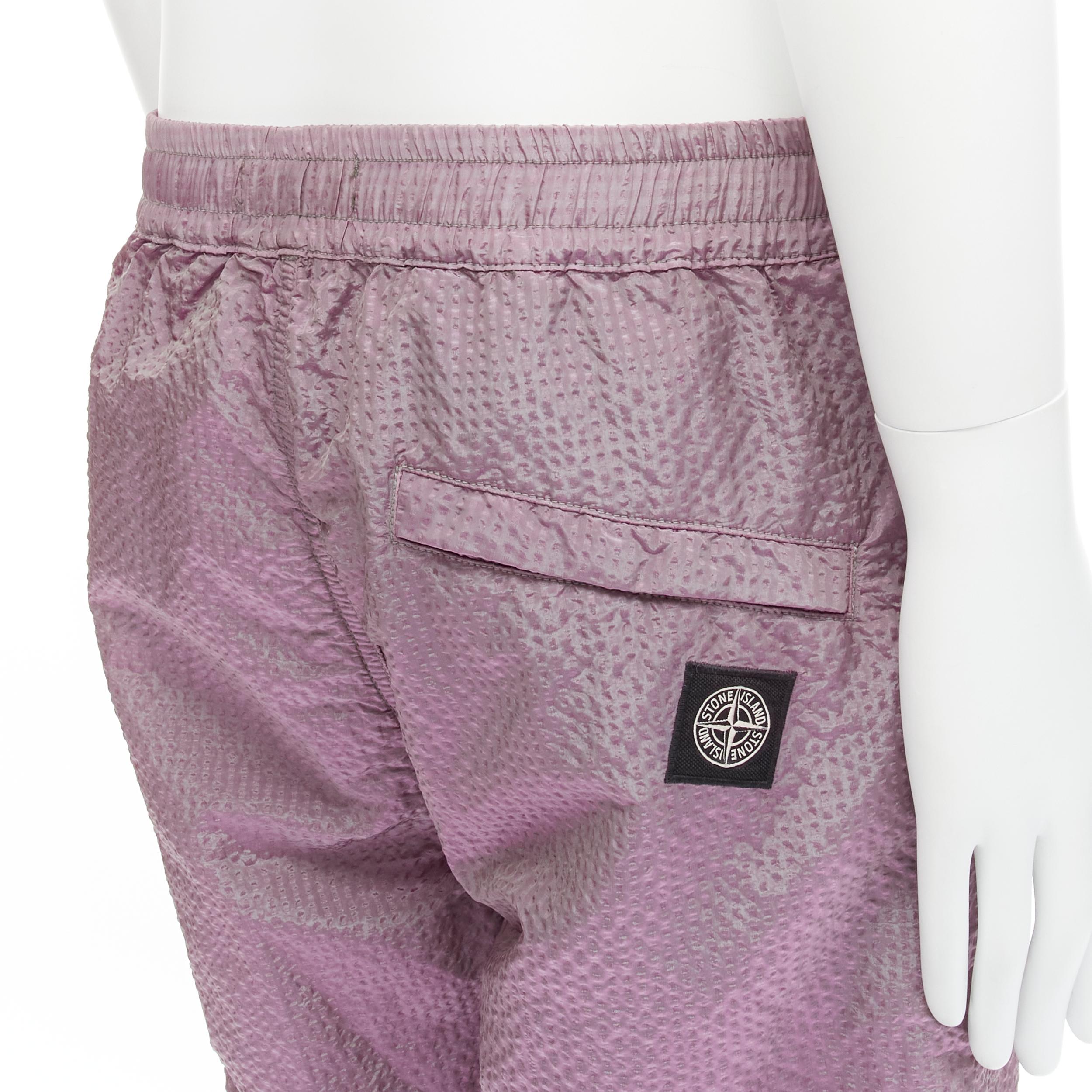 STONE ISLAND iridescent purple seersucker nylon track pants M 
Reference: CNLE/A00175 
Brand: Stone Island 
Material: Nylon 
Color: Purple 
Pattern: Solid 
Extra Detail: Elasticated waist. Zipped pockets. Zip fly. Elasticated cuff. 

CONDITION: