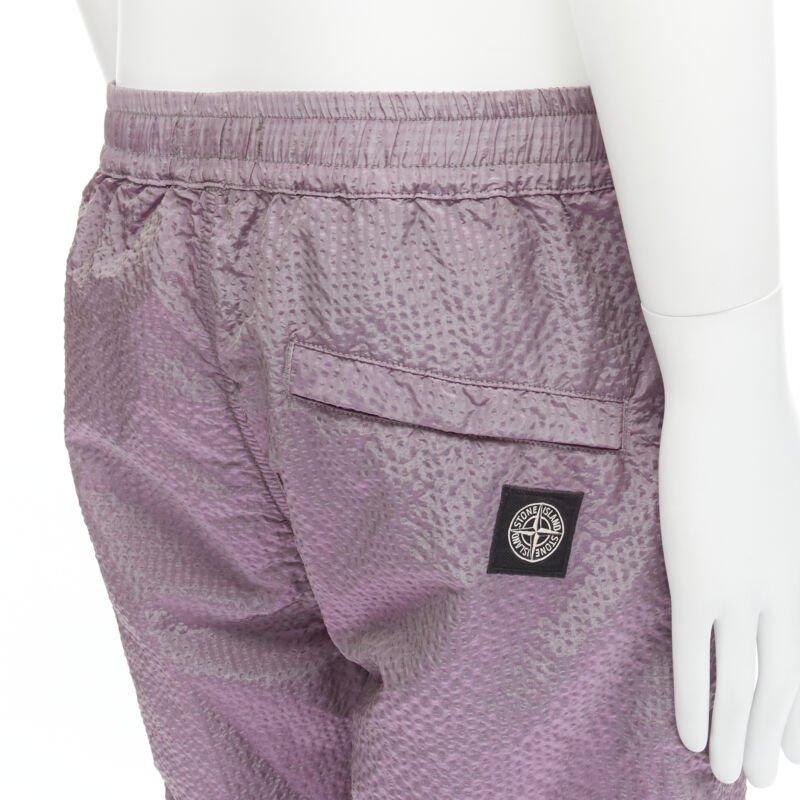 STONE ISLAND iridescent purple seersucker nylon track pants M
Reference: CNLE/A00175
Brand: Stone Island
Material: Nylon
Color: Purple
Pattern: Solid
Extra Details: Elasticated waist. Zipped pockets. Zip fly. Elasticated cuff.

CONDITION:
Condition: