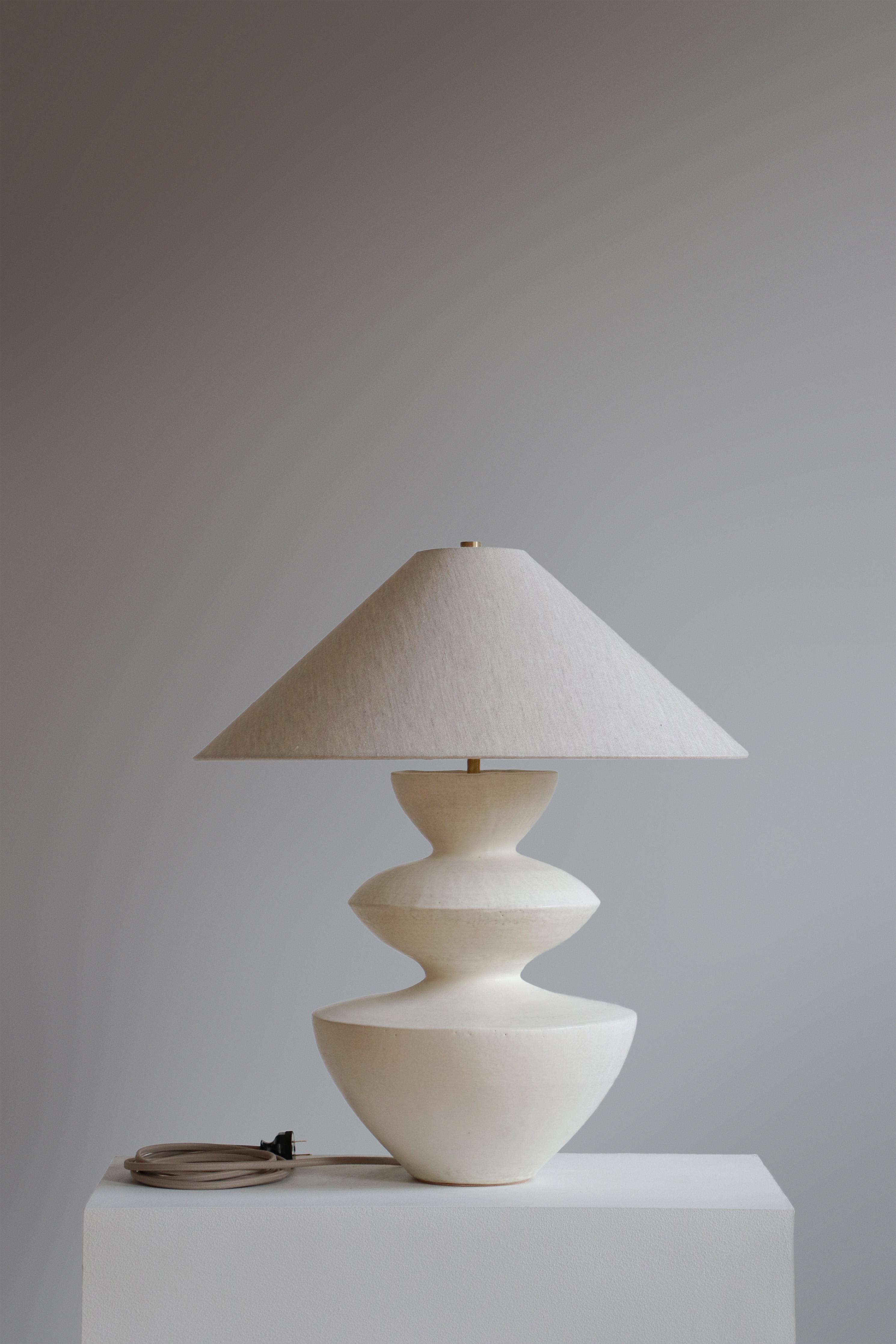 Stone Janus Table Lamp by Danny Kaplan Studio
Dimensions: ⌀ 51 x H 59 cm
Materials: Glazed Ceramic, Unfinished Brass, Linen

This item is handmade, and may exhibit variability within the same piece. We do our best to maintain a consistent product,