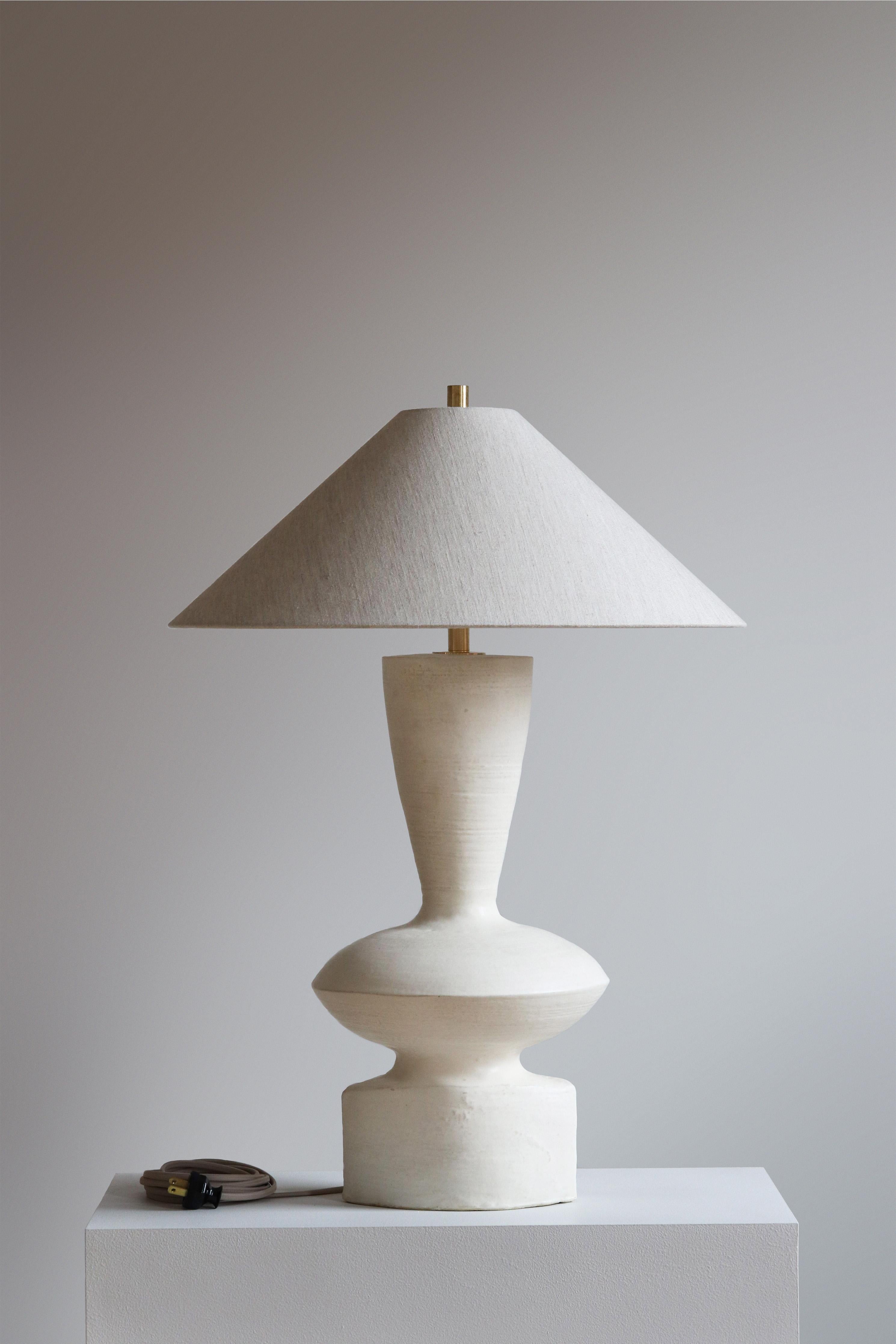 Stone Luna Table Lamp by Danny Kaplan Studio
Dimensions: ⌀ 51 x H 71 cm
Materials: Glazed Ceramic, Unfinished Brass, Linen

This item is handmade, and may exhibit variability within the same piece. We do our best to maintain a consistent product,