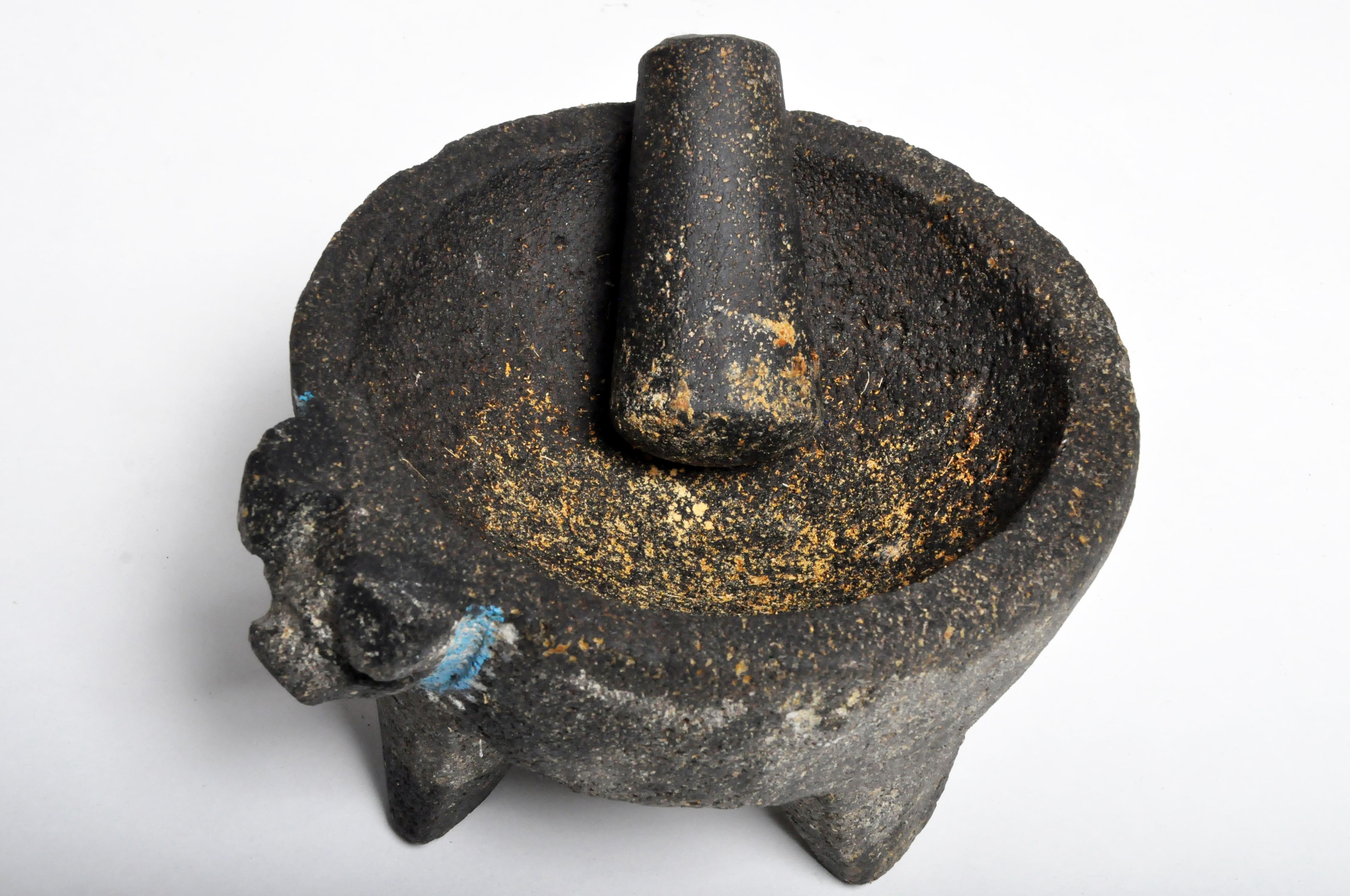 This mortar is from India and was made from coarse-grained stone, c. 1950. Wear consistent with age and use.