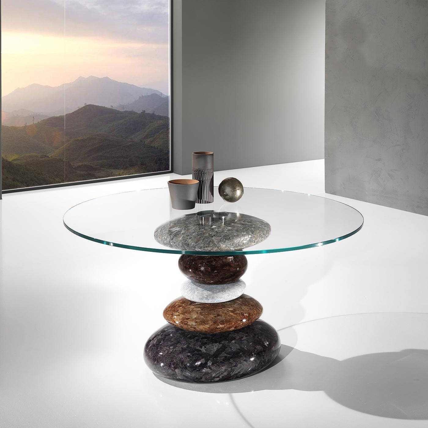 This sublime piece of decor pays tribute to Japan's artistic Suiseki tradition of water-shaped stone. The table's stunning base features 5 elements carved and finished by hand from a single block of Crystal Stone®, a unique alabaster quarried