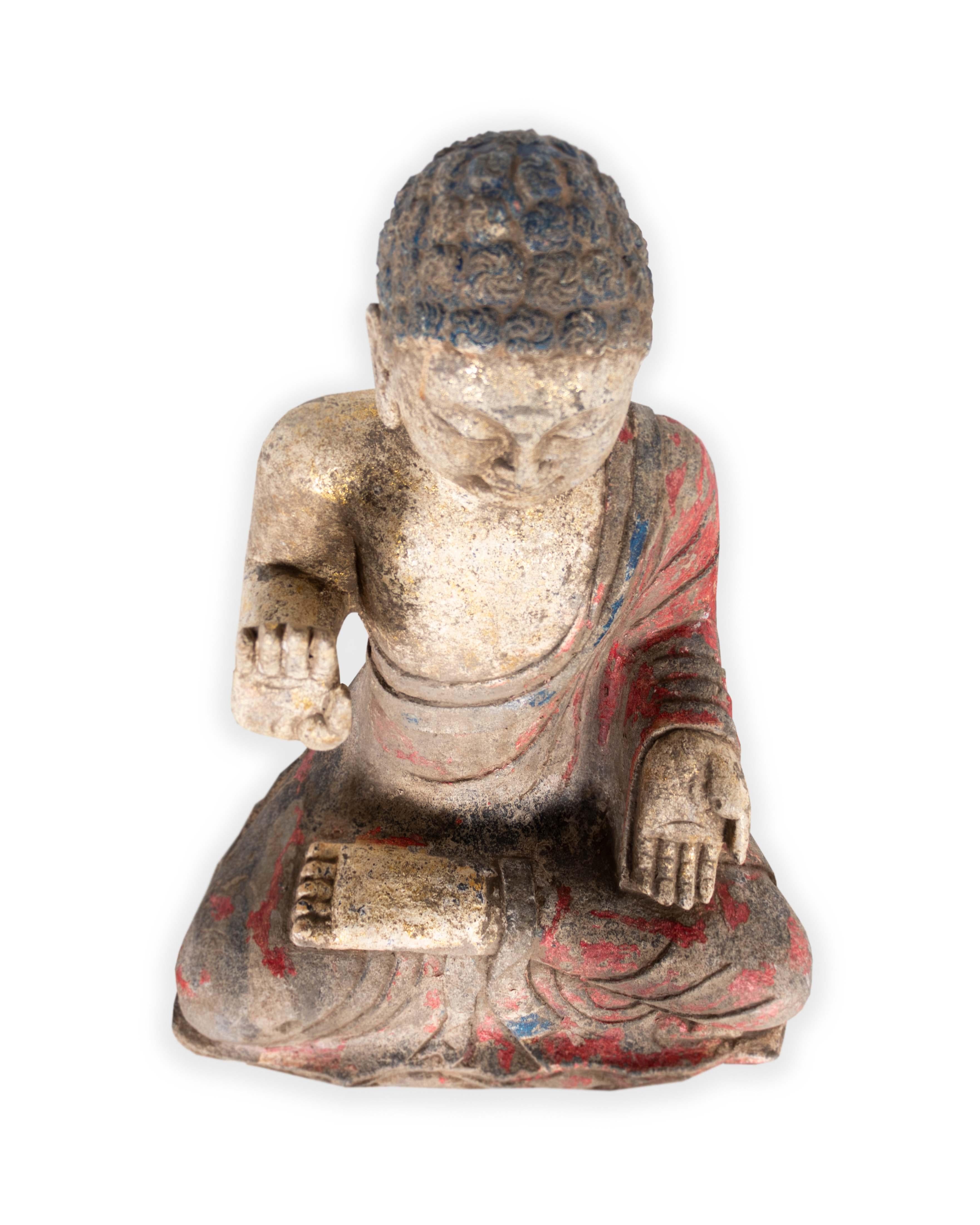 Stone seated Buddha with pigmented decoration. 

A Piece from the Estate Collection. Exclusive to Brendan Bass.