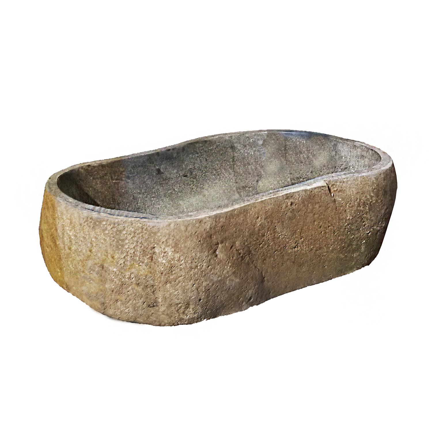 A solid stone sink or basin, hand-crafted in Indonesia. 
Hand-carved from volcanic rock, the outside of the piece preserves its naturally rugged stone texture, while the inside has been polished for a smooth, even and shiny surface. 

Can be used as