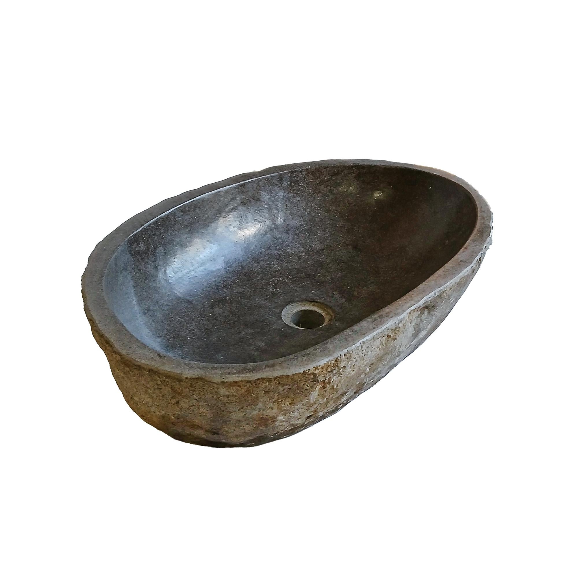 A solid stone sink or basin, hand-crafted in Indonesia. 

Hand-carved from volcanic rock, the outside of the piece preserves its naturally rugged stone texture in yellow and light beige colors, while the inside has been polished for a smooth and
