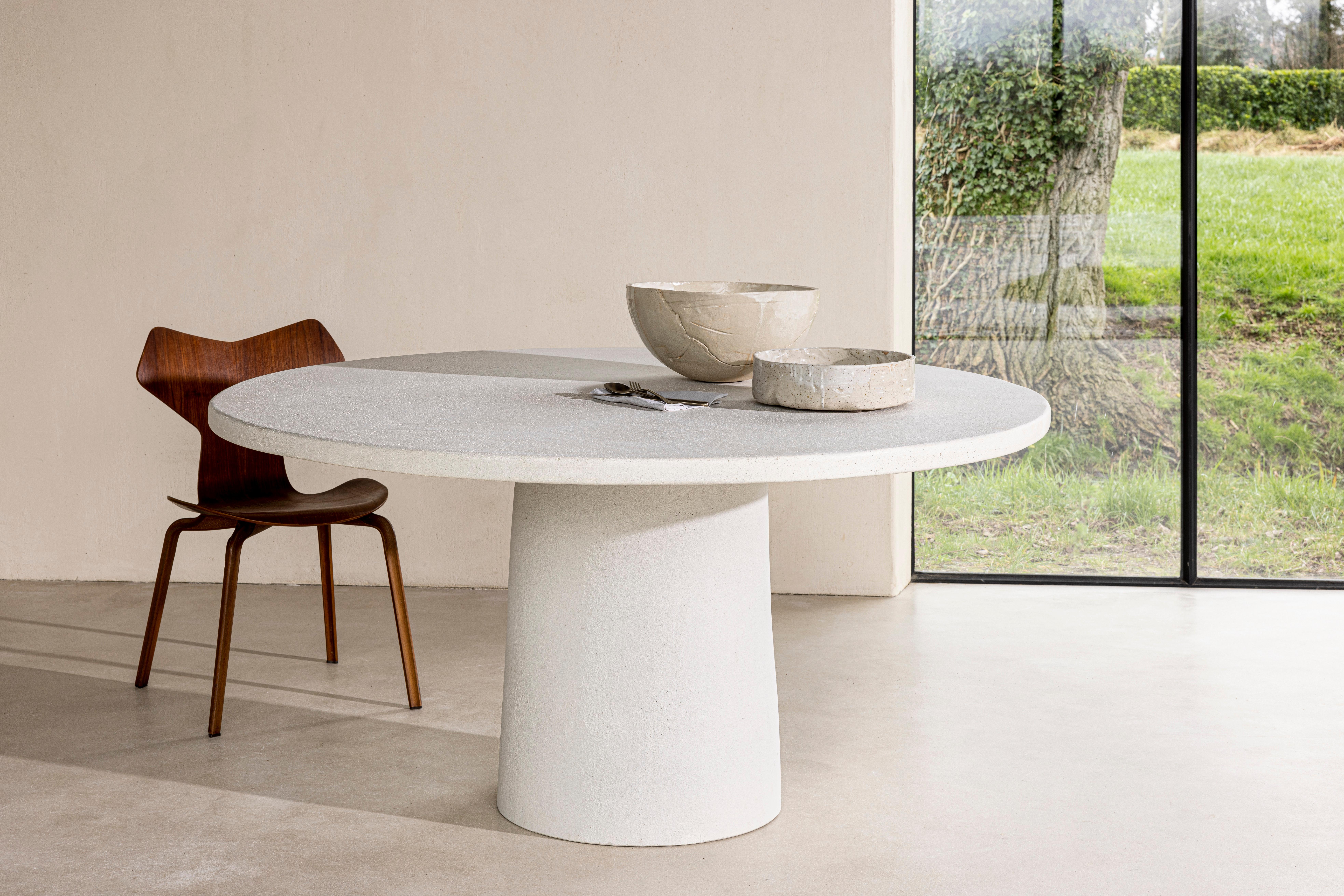 Stone table by Studio Loho
Dimensions: D 120 x H 75 cm
Materials: clay
Available in other sizes: From 120cm to 220cm.

The table is made of two parts: a tabletop on a central pedestal. The tabletop is made of composite concrete, having mostly
