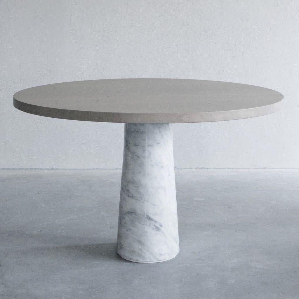 Stone table with carrara marble by Van Rossum.
Dimensions: D140 x W140 x H75 cm
Materials: Solid French oak, carrara marble.

The wood is available in all standard Van Rossum colors, or in a matching finish to customer’s own sample.
The base is