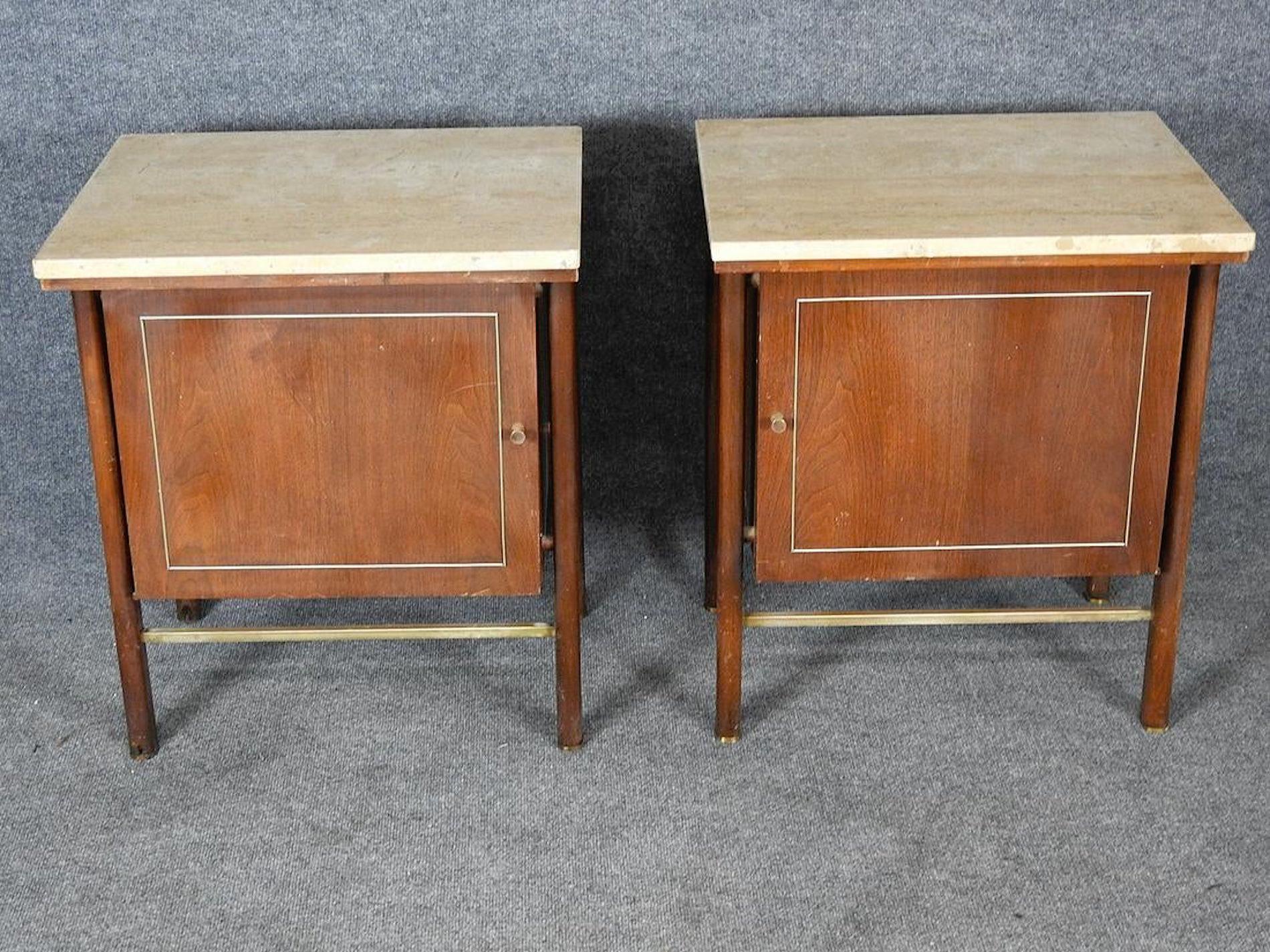 Pair of midcentury Paul McCobb style nightstands with closed door storage, brass trim, travertine tops.
(Please confirm item location - NY or NJ - with dealer).
 