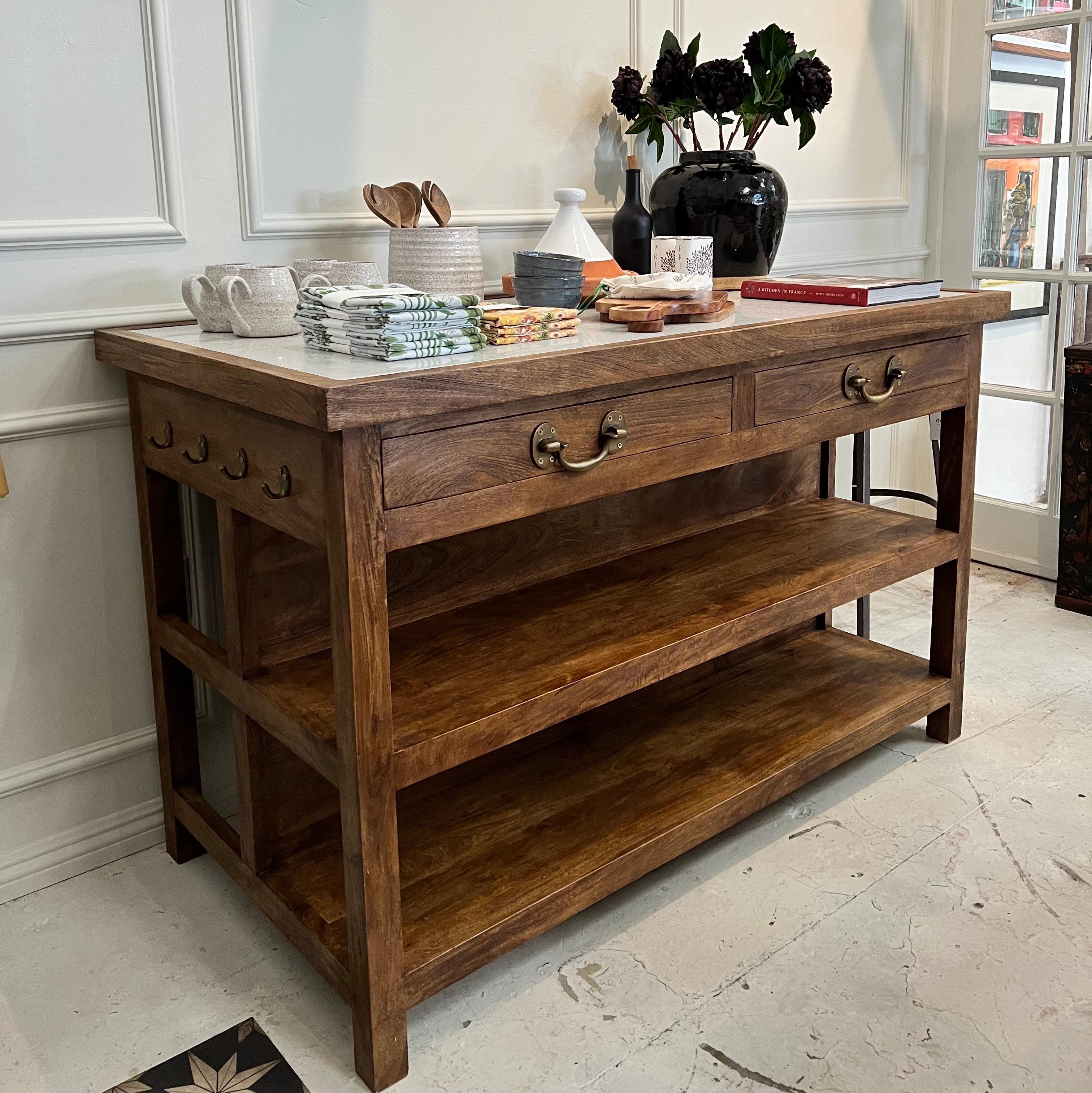 This beautiful and functional free standing kitchen island features medium brown natural wood finish and white stone top. Hooks and hanger rod for storage as well as shelves and drawers. Back side offers space to fit 2-3 bar stools

Measures: 58