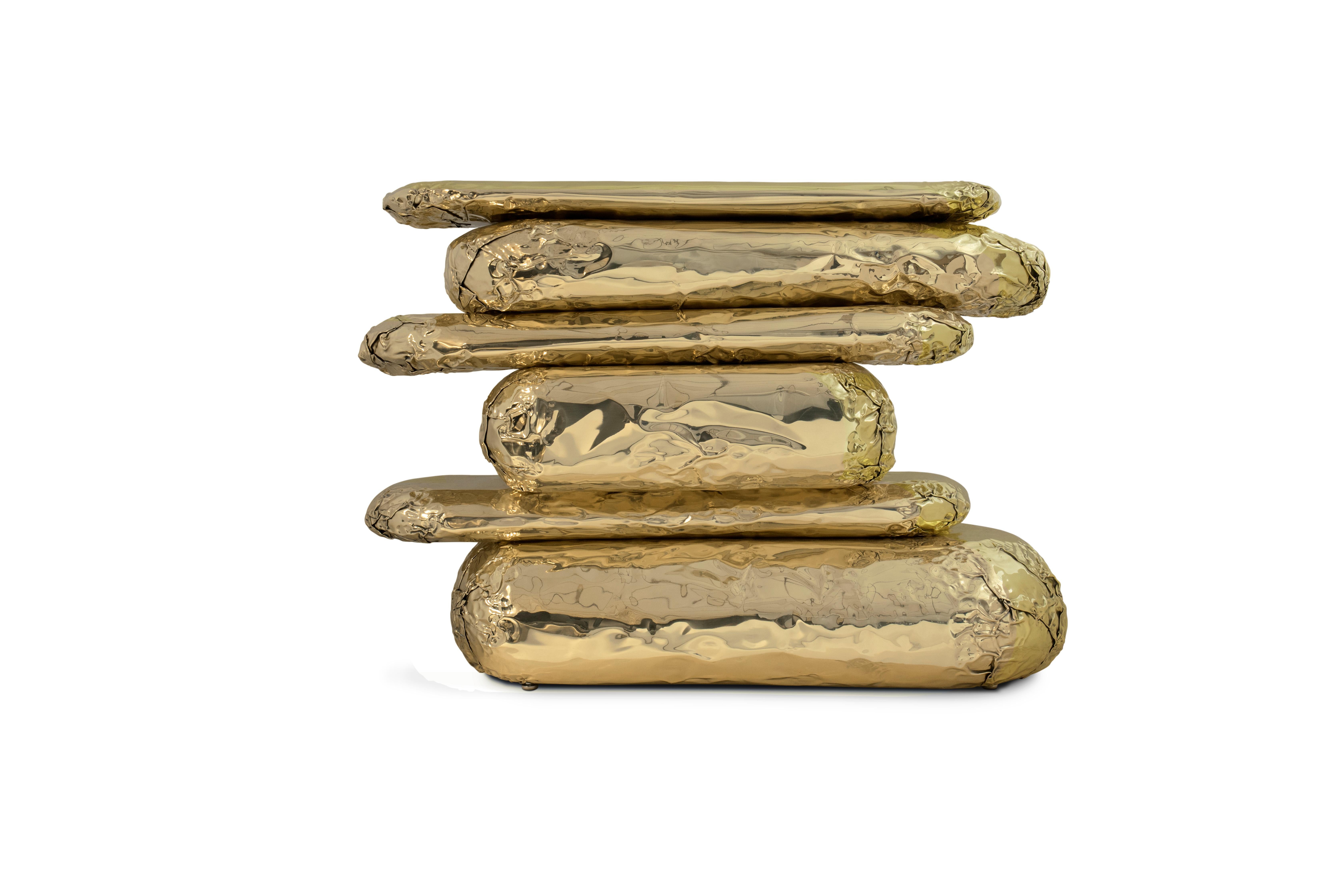 Finding inspiration in the prehistoric monument Stonehenge, positioned asymmetrically and composed by a striking finishes and materials brass and marble. This piece promises to elevate your living space to the next level. The metallic hues make an