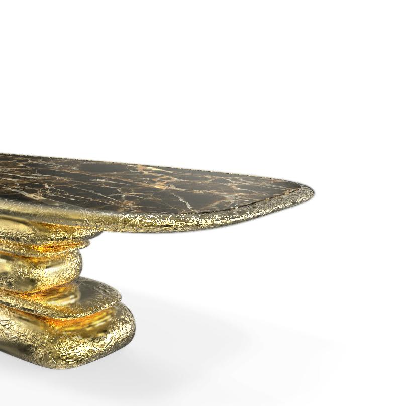 Finding inspiration in the Prehistoric monument Stonehenge, positioned asymmetrically and composed by a striking finishes and materials brass and marble. This piece promises to elevate your living space to the next level. The metallic hues make an