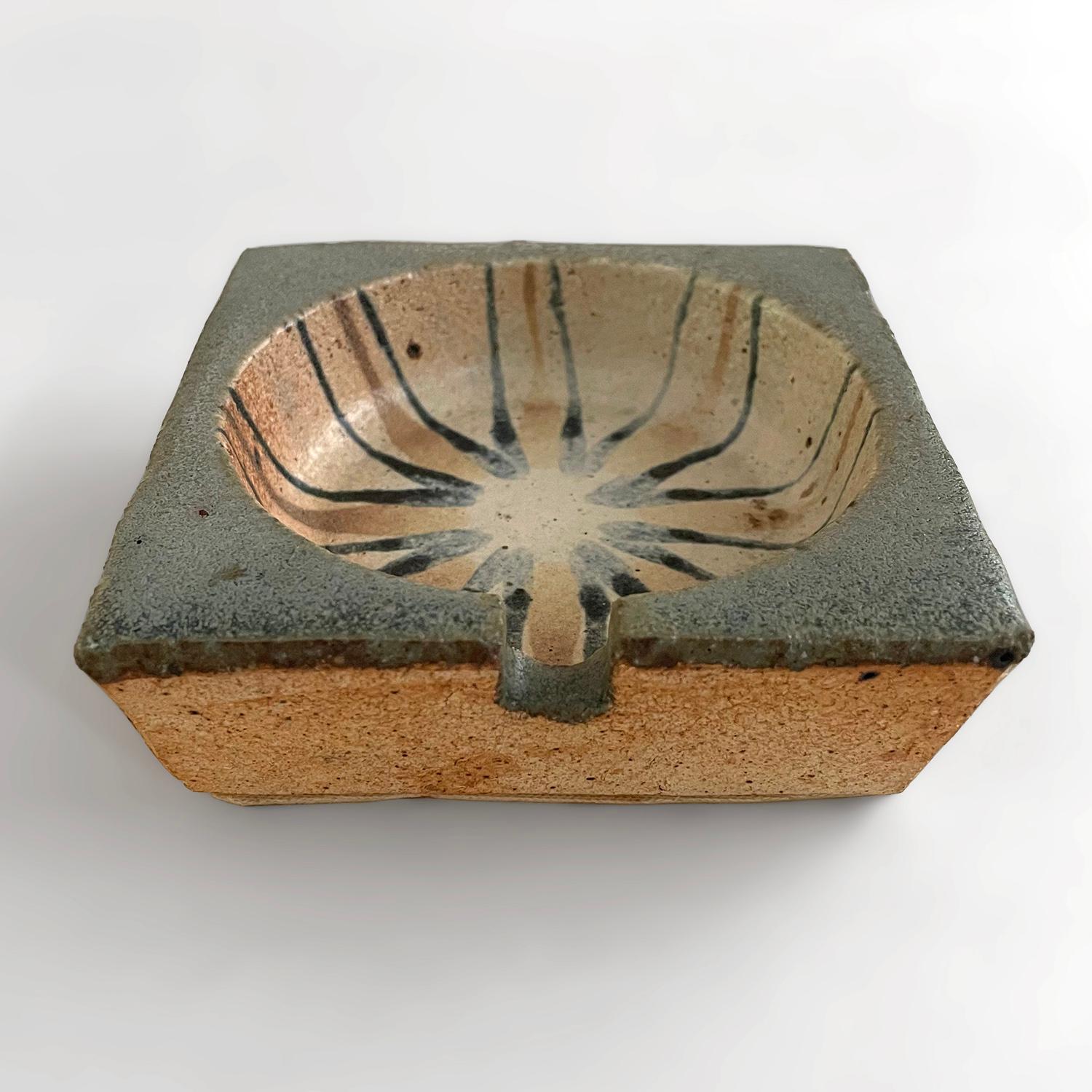 1970’s stoneware ashtray
France, circa 1970’s
This handmade piece has a wonderful organic composition and feel
Neutral toned stoneware decorated with a free form orbital sun pattern and multi layered two toned accents
Patina from age and