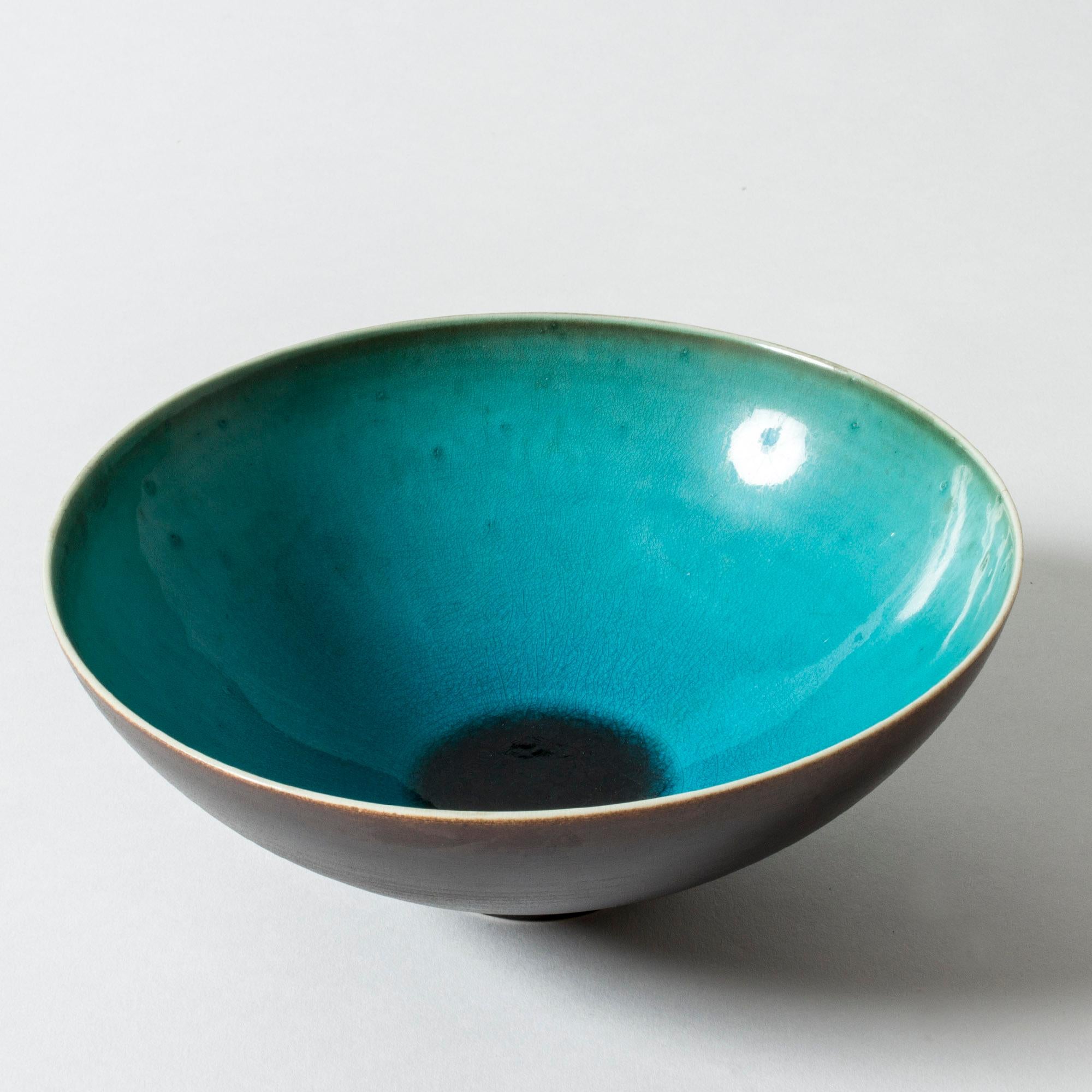 Stoneware bowl by Friedl Holzer-Kjellberg. Smooth lines with dark brown outside and vibrant aquamarine glaze inside.