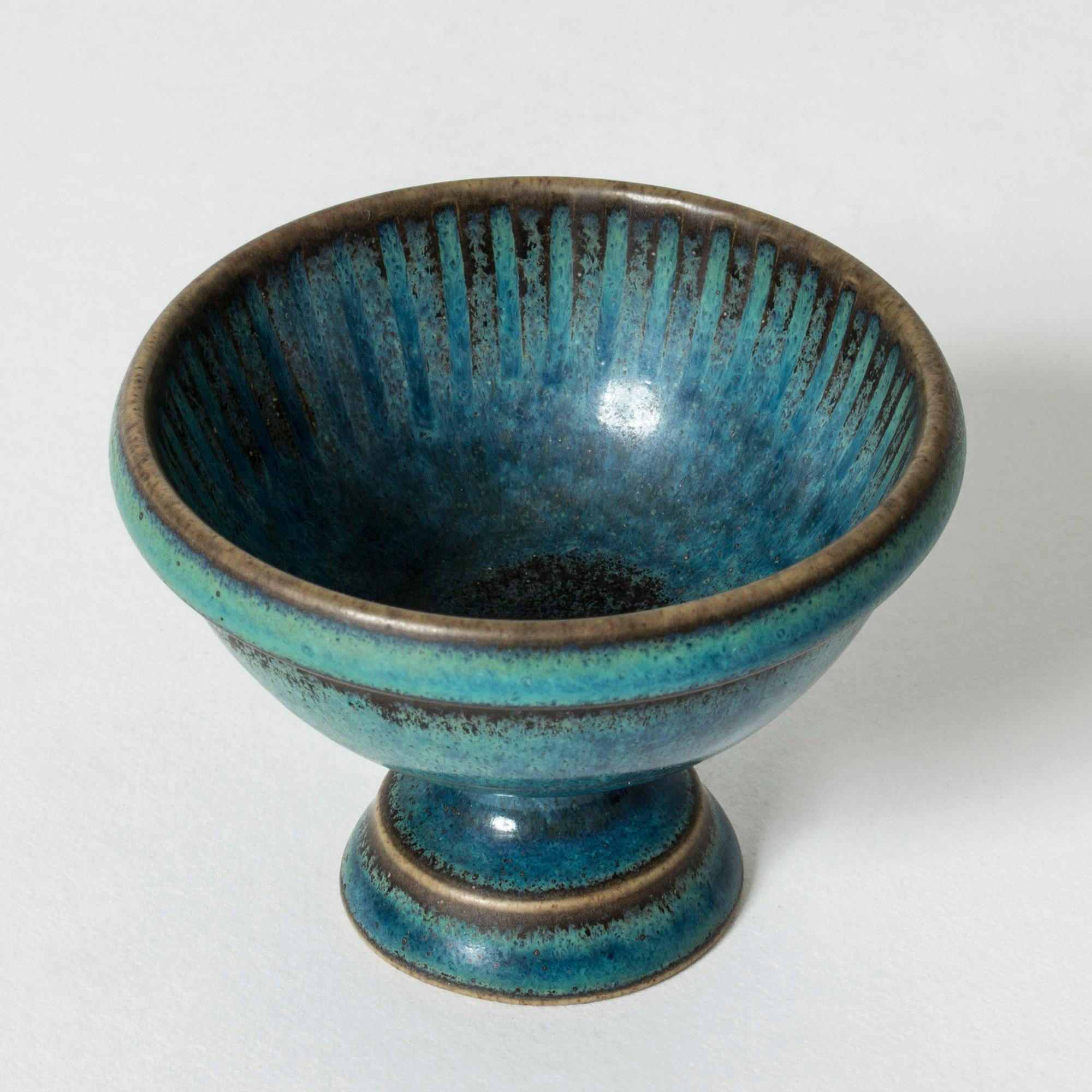 Cute unique stoneware bowl on foot by Stig Lindberg. Vibrant blue glaze and a graphic embossed pattern.