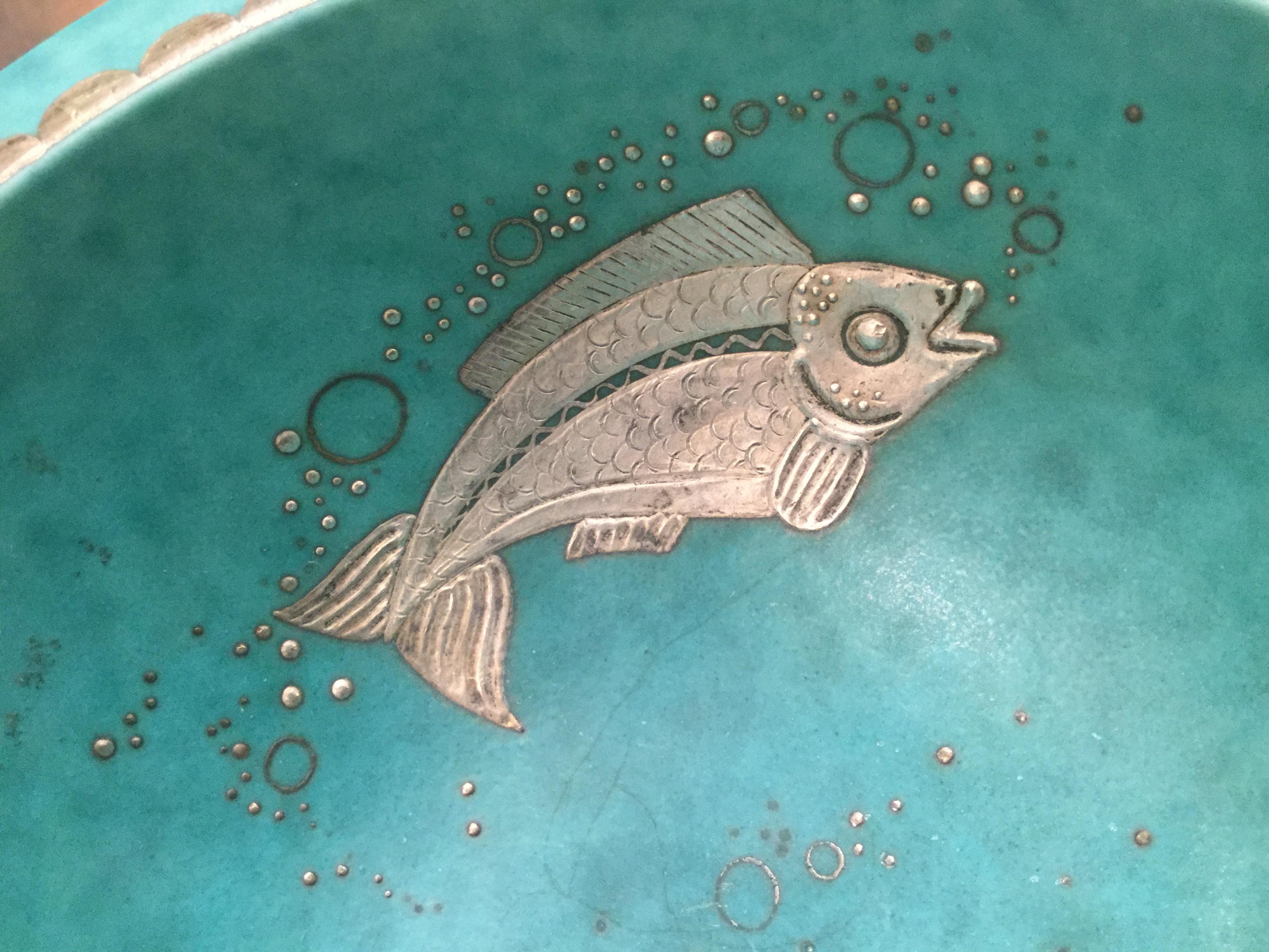 Stoneware bowl with an Evergreen glaze, the inside decorated with a silver fish and bubbles. Silver contributed by Argenta.