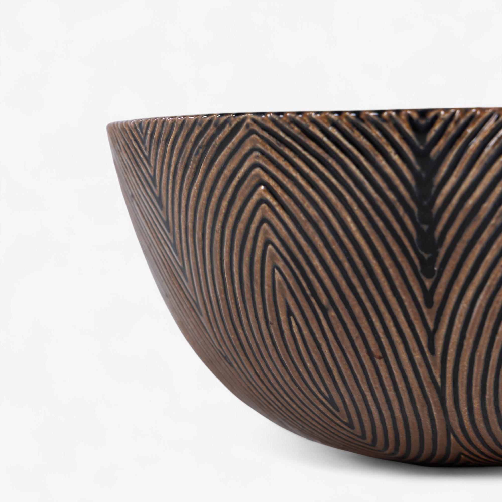 Large and rare fluted bowl, glazed with a Sung glaze and a mussel glaze on the inside. Model 20675. Signed by Royal Copenhagen. Designed in 1944 by Axel Salto.