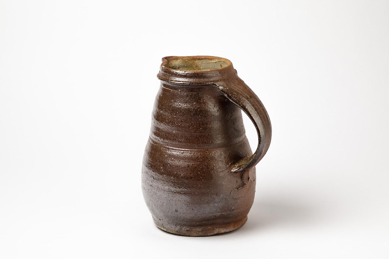 Hervé Rousseau

Beautiful ceramic handmade pitcher by French ceramist.

Realised in Boisbelle near La Borne.

Elegant brown fire ceramic effect.

Original perfect condition.

Dimension: 21 x 17 x 13 cm.