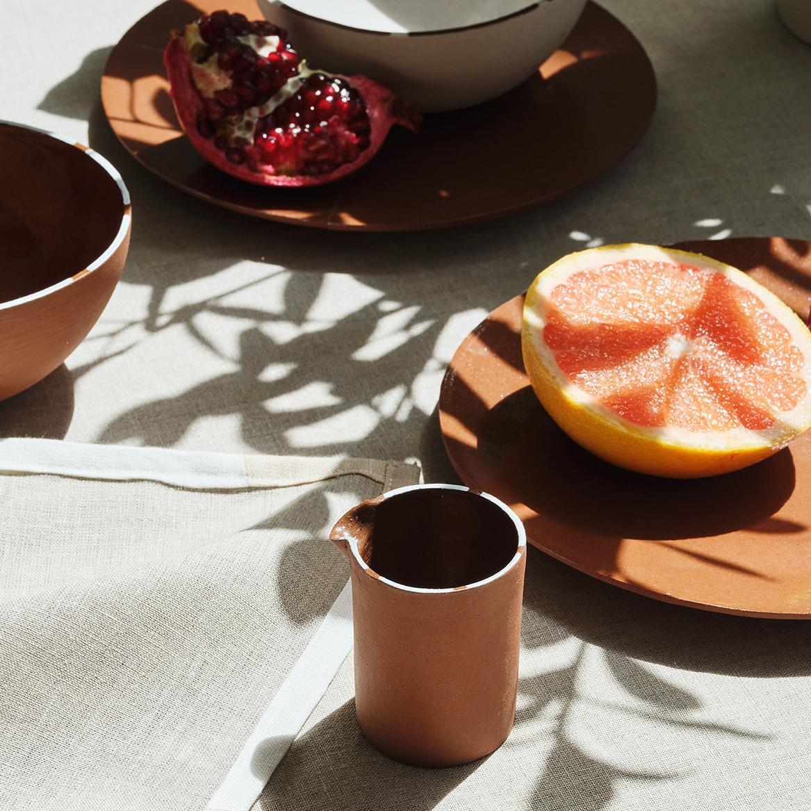 The pieces are slip cast in London, made from stoneware in small batches. The hand painted details around the rim of each item in the collection is created by glaze in a complimentary colour to the body of each piece.

CUSTHOM studio has developed