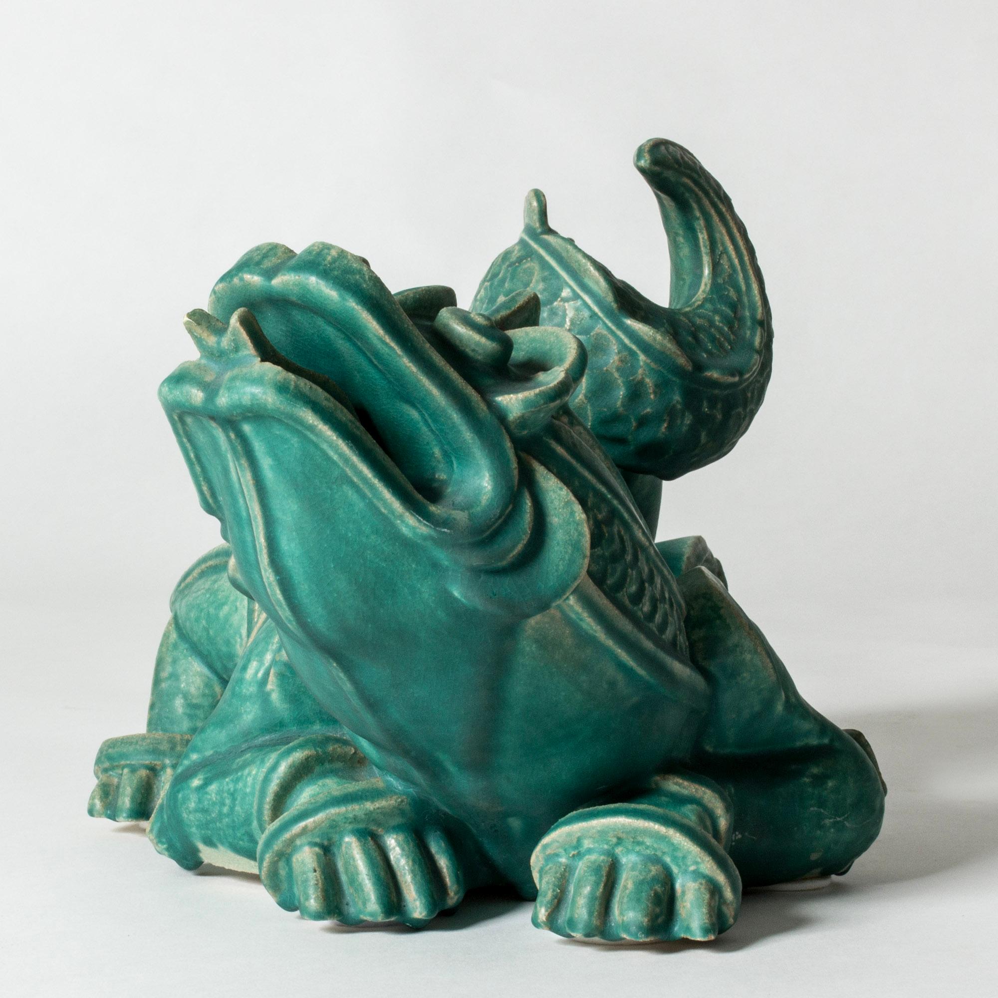 Stunning, unique dragon sculpture by Wilhelm Kåge, made from stoneware with beautiful green glaze. Rare, large size. Very expressive and lively design, inspired by Chinese Ming era dragon sculptures and executed in Kåge’s distinct artistic style.