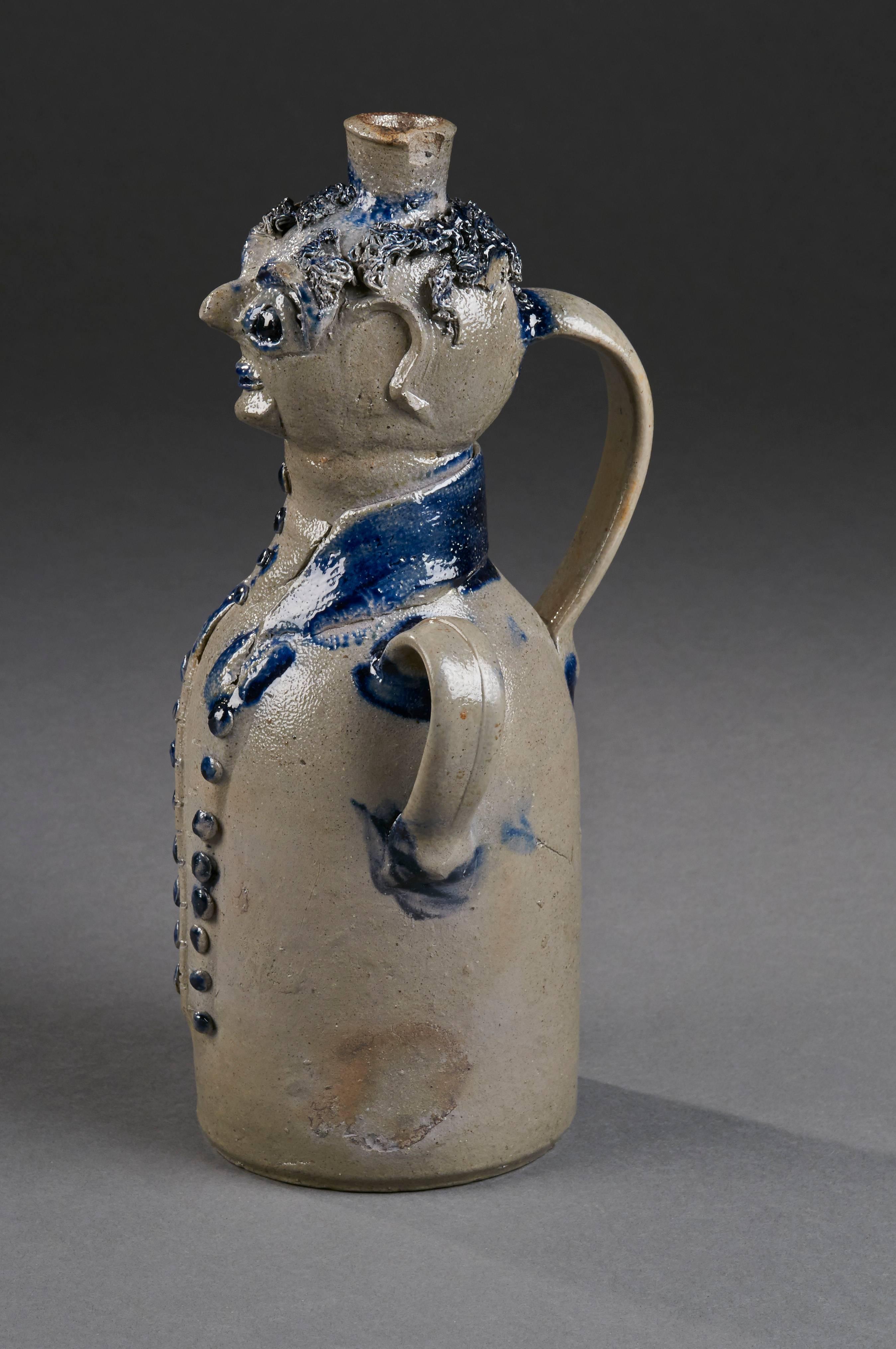 Mid-Atlantic, circa 1850, stoneware with cobalt and applied decoration
Measures: H 13”.

Extremely rare form with imaginative interpretation of a man in a cutaway coat.
 