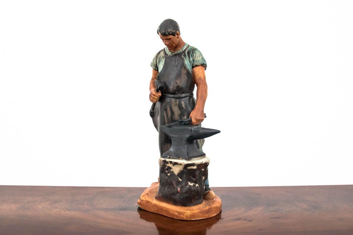 Stoneware figurine of a blacksmith from the Danish manufacture Bing & Grondahl. Figurine designed by Axel Locher. Number: 2225
Signature dated: 1970-1983.
