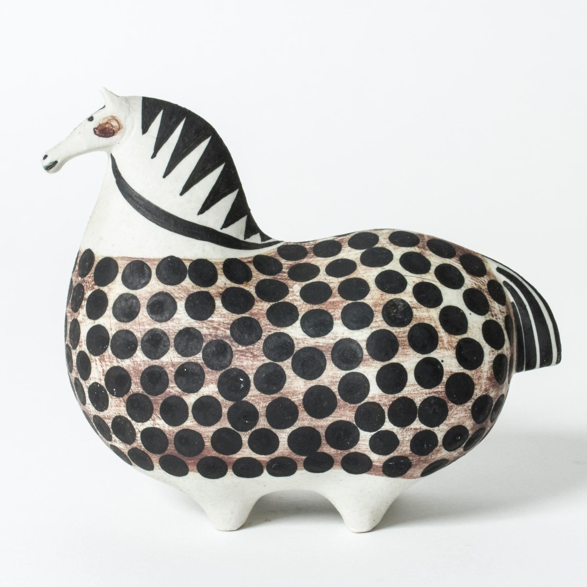 Adorable ceramic horse figurine by Stig Lindberg, called “Springare”, meaning “Steed”. The stylized horse is painted with a brown and polkadot pattern over the body.

The story goes that at the first Studio exhibition of “Springare”, a cavalry